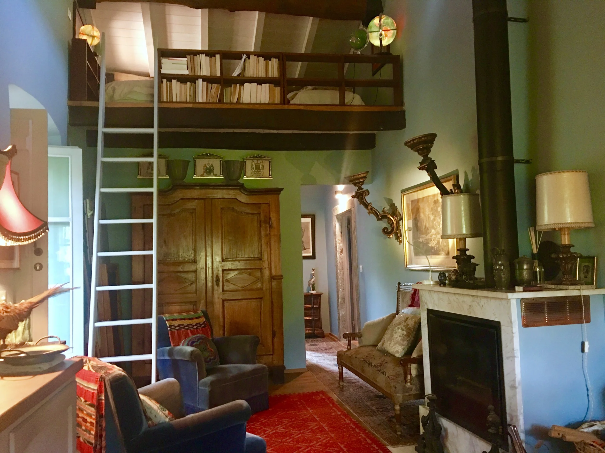 Entrance door on the left, loft space with two single beds above, corridor to the Bathroom & MBR from open-space Living & Dining area.