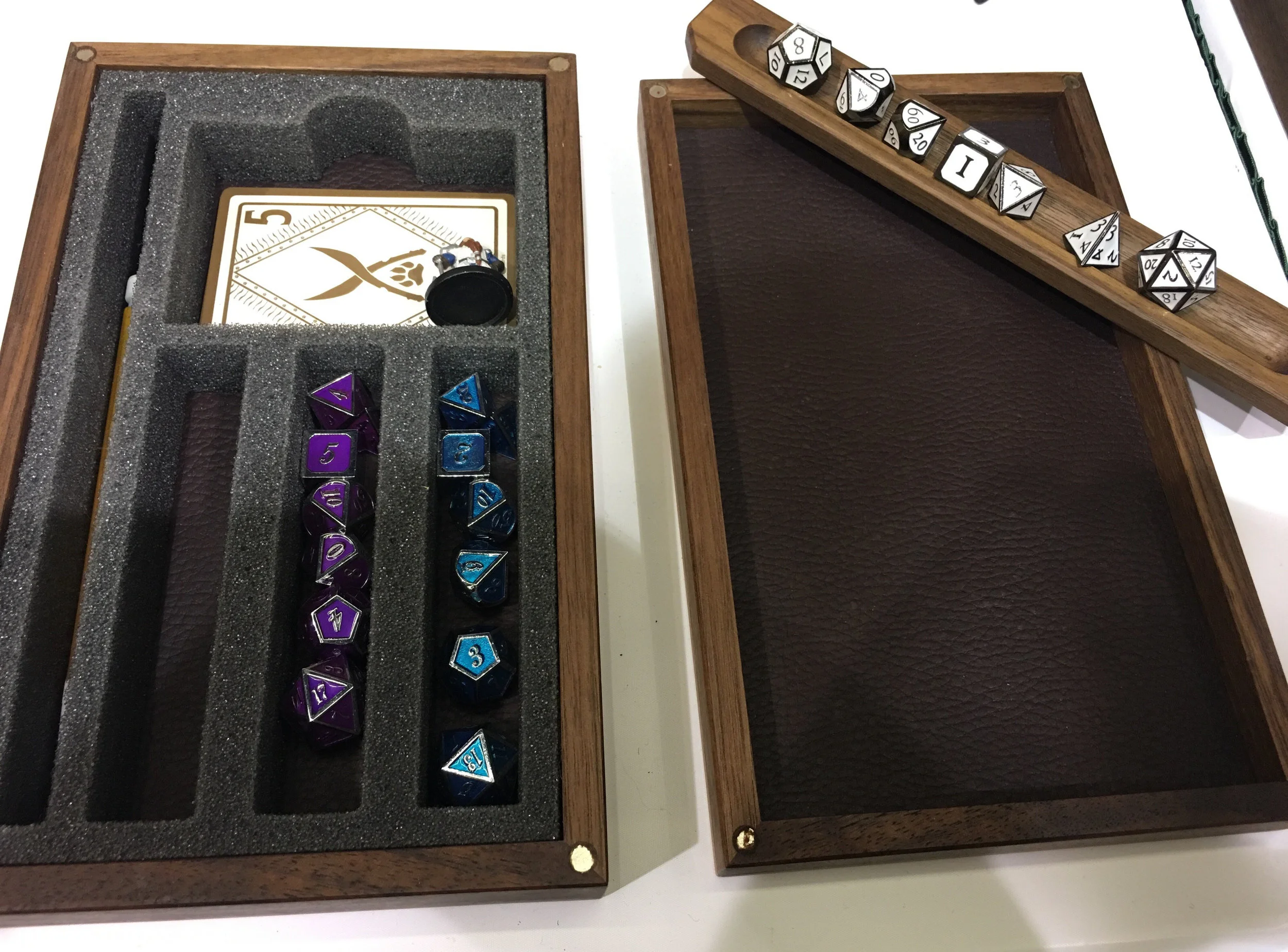 Room for 3 full sets of dice, a spot for your mini, pen or pencil, spell cards, and however many extra dice you probably have.