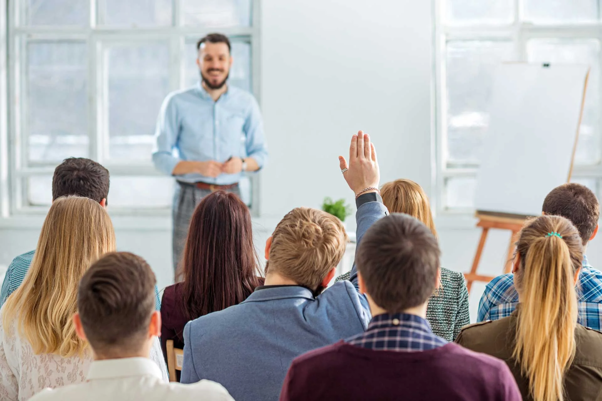 student-raising-their-hand-during-lecture.jpg