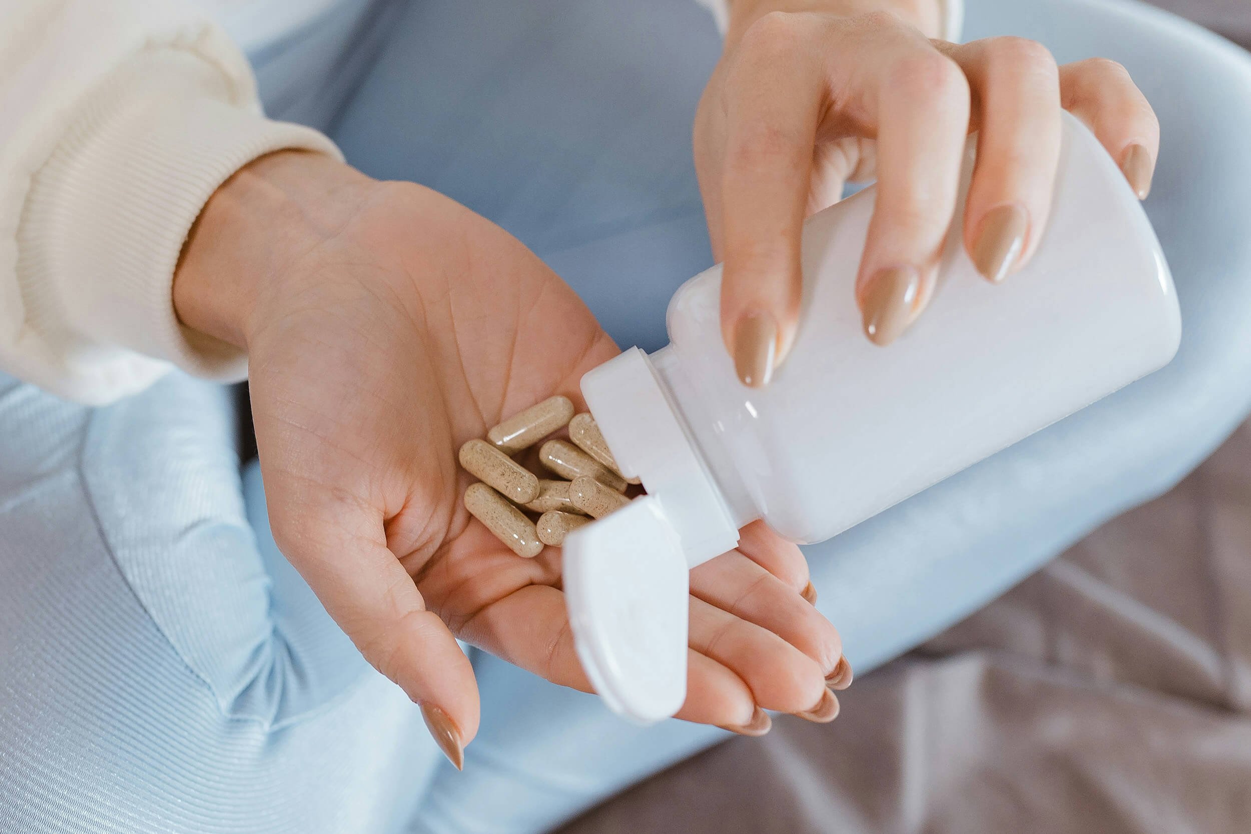 Woman holding homeopathic supplements for supporting menopause