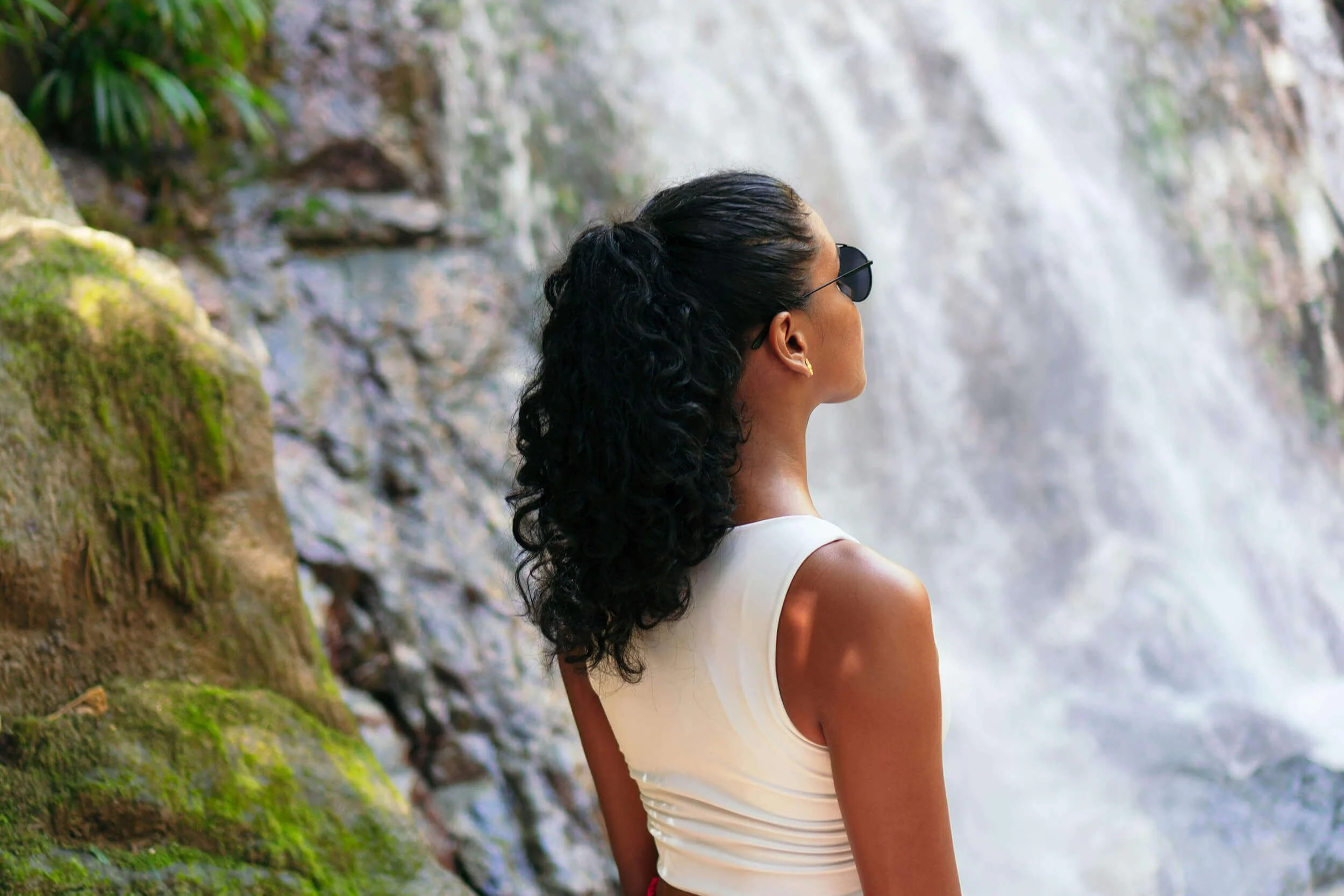 Woman looking at waterfall representing hydrotherapy