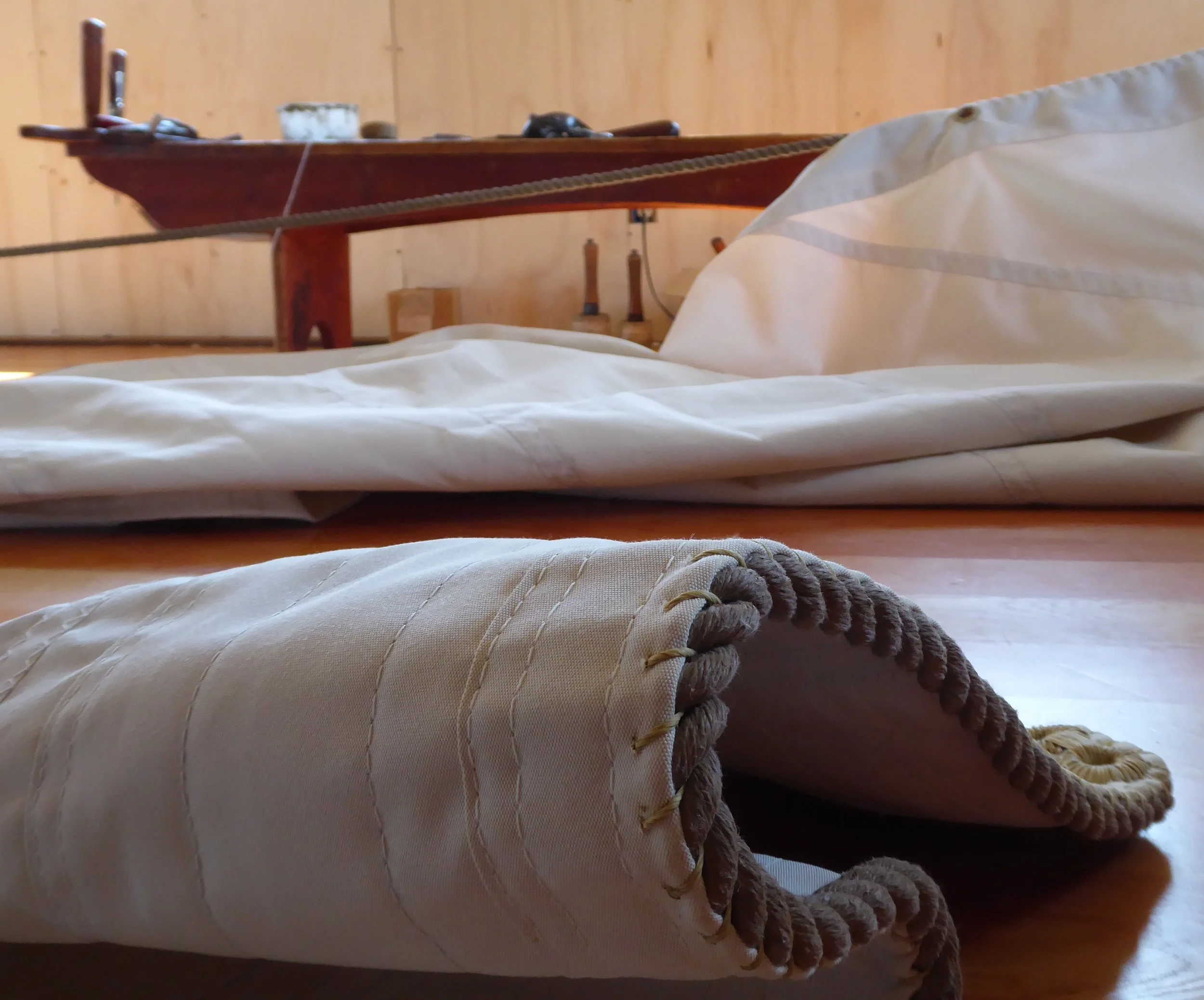 Next we reinforce the edge of the sail by hand sewing rope to all of the edges.