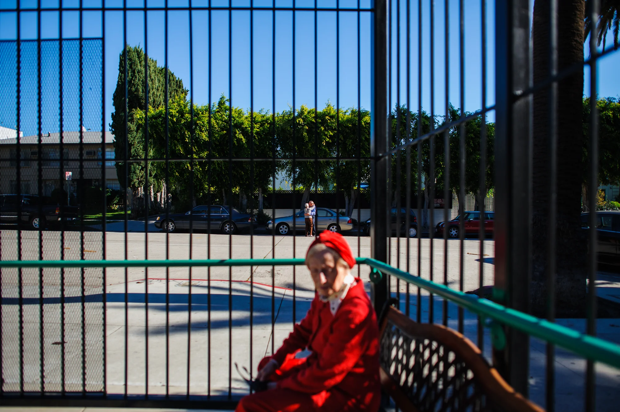 Jeanie and Will embrace in the street, as Adina sits inside the gate of the retirement home.