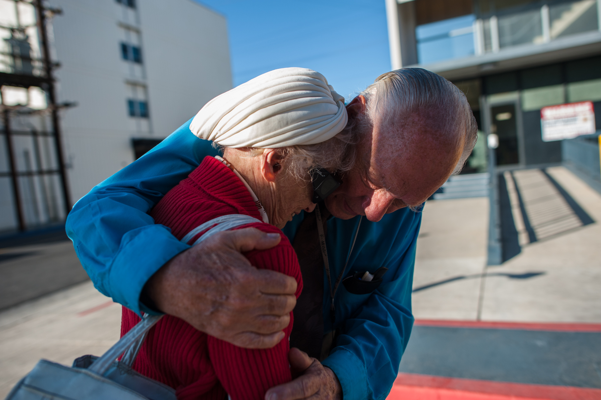  Will comforts Adina who does not want him to leave, as they stand near the entrance of the retirement home where she lives.  