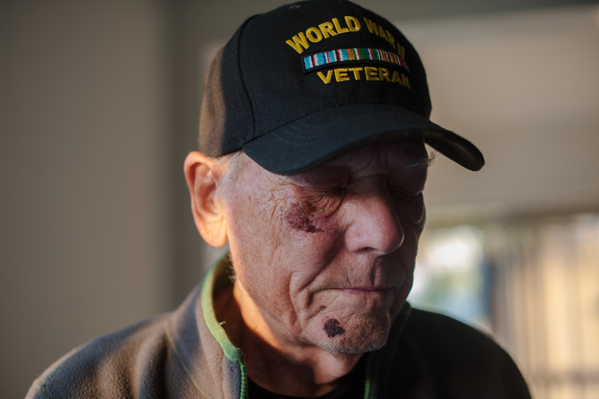  Will stands with his eyes closed, wearing his World War II Veteran cap.  