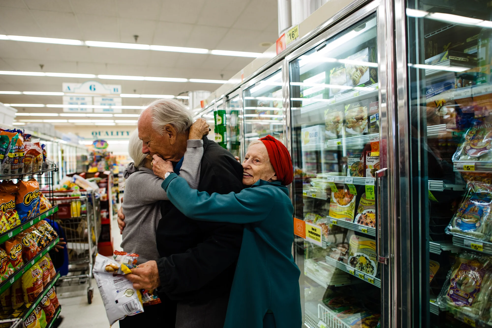 Jeanie and Adina embrace Will in the supermarket aisle.