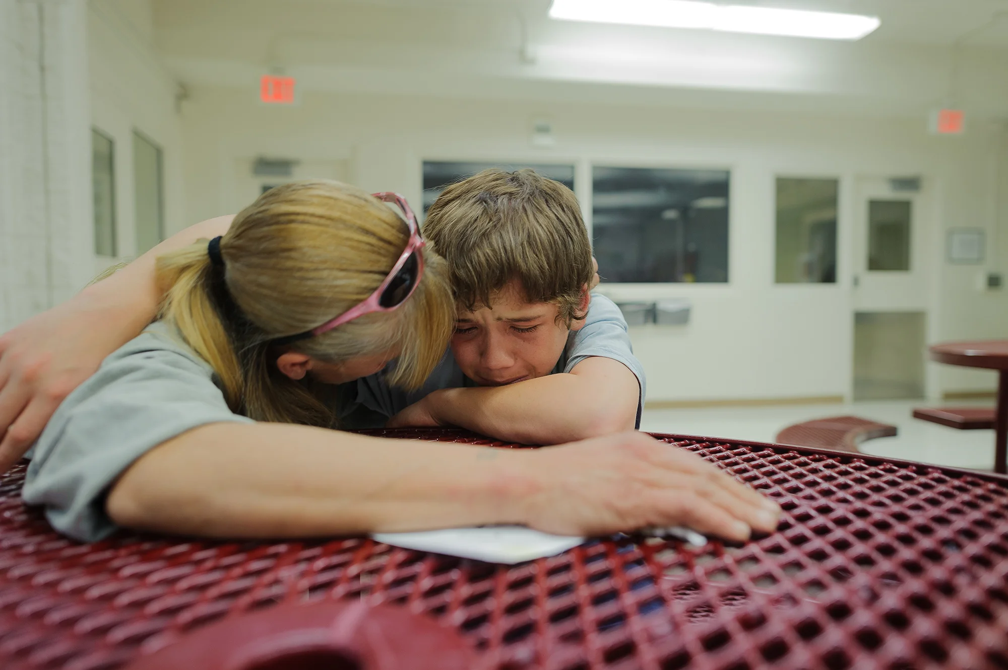Vinny, age 13, cries during a visit with his mom, Eve, at the juvenile detention center. He says, “get me out mom, just get me out,” 2012.