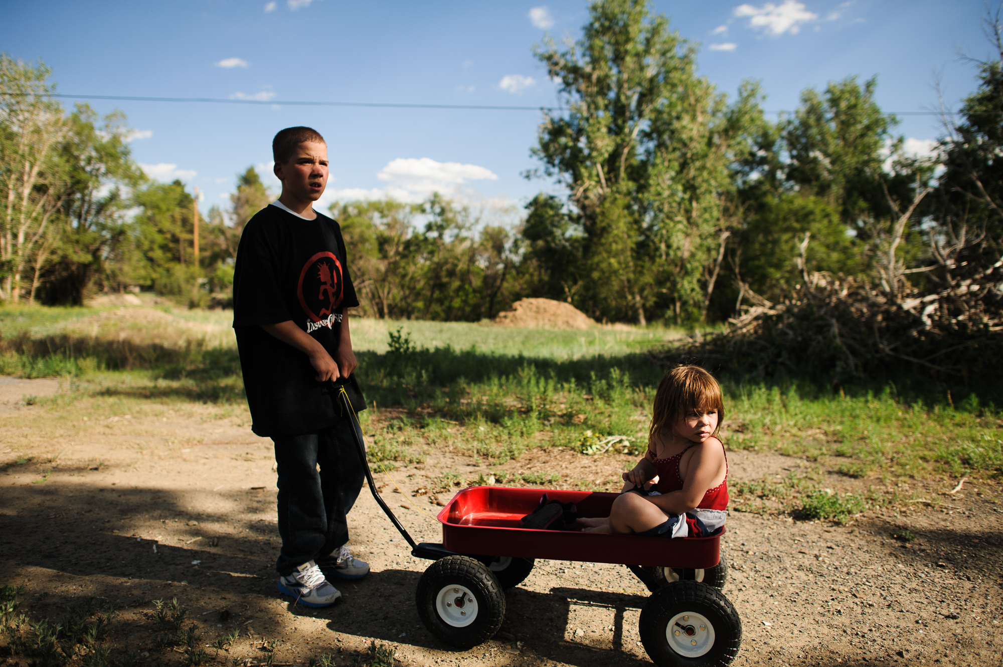  Vinny, age 13, pulls Elycia in a wheelbarrow during a family visit, 2012. 