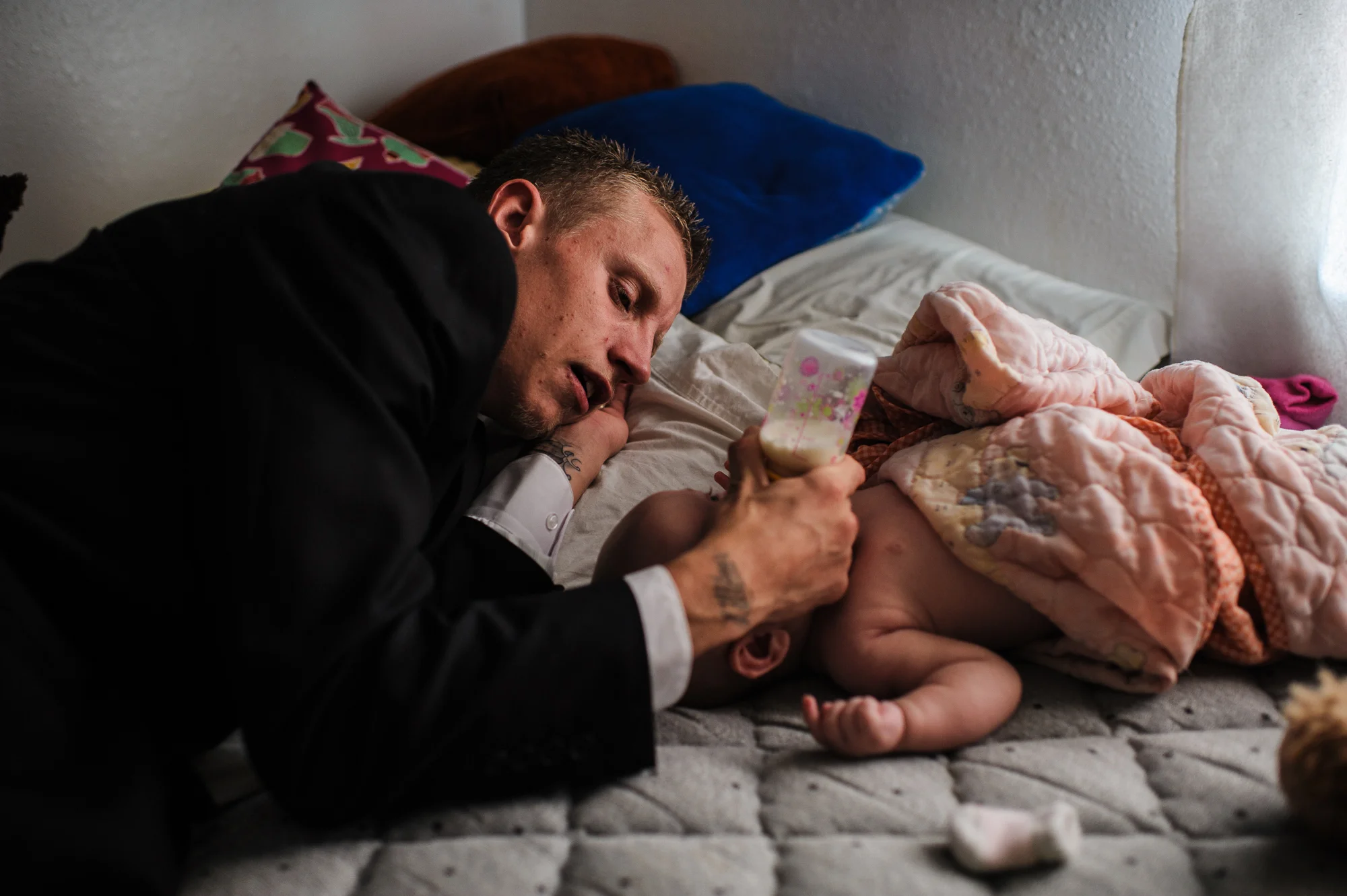David, age 21, feeds Mary Jane, age 4 months, before his trial, 2014.