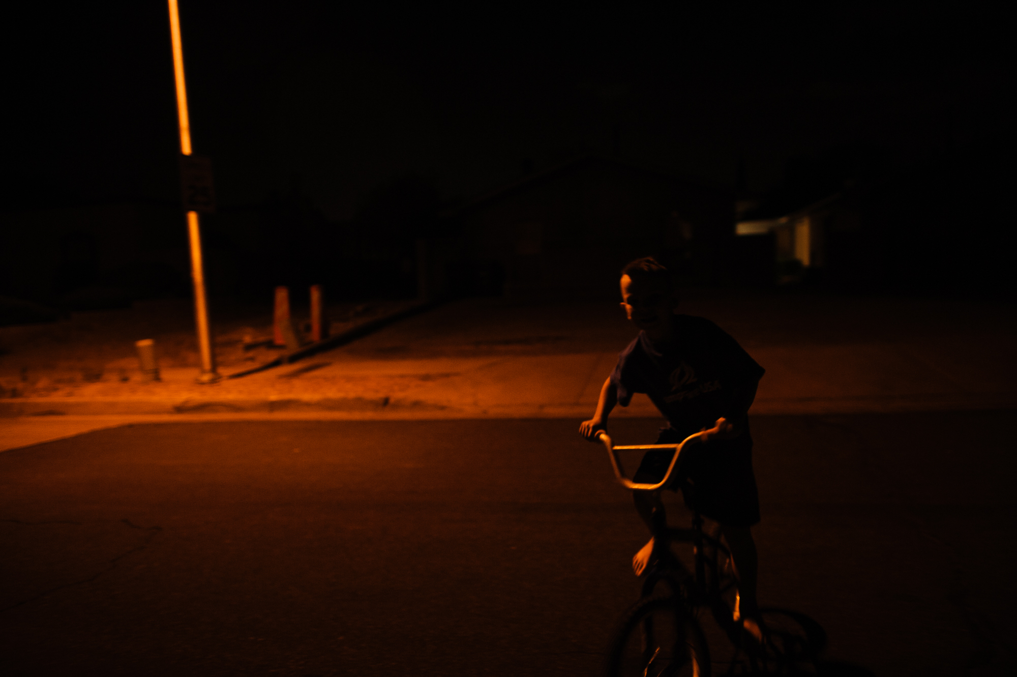  Michael, age 7, rides a bike at night, 2012.&nbsp; 