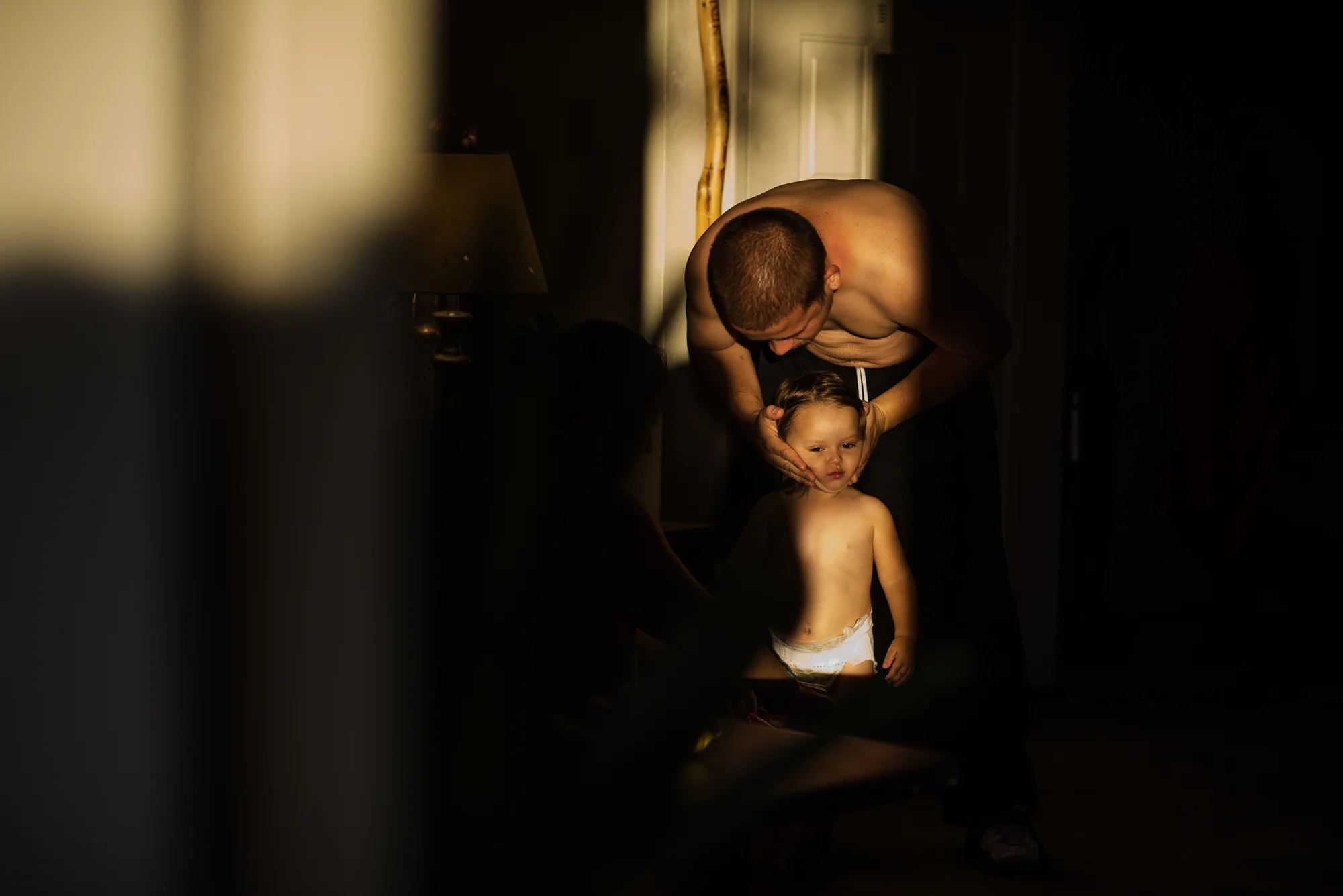 Vinny, age 18, holds his daughter Jordyn’s face as they prepare for an outing, 2017.
