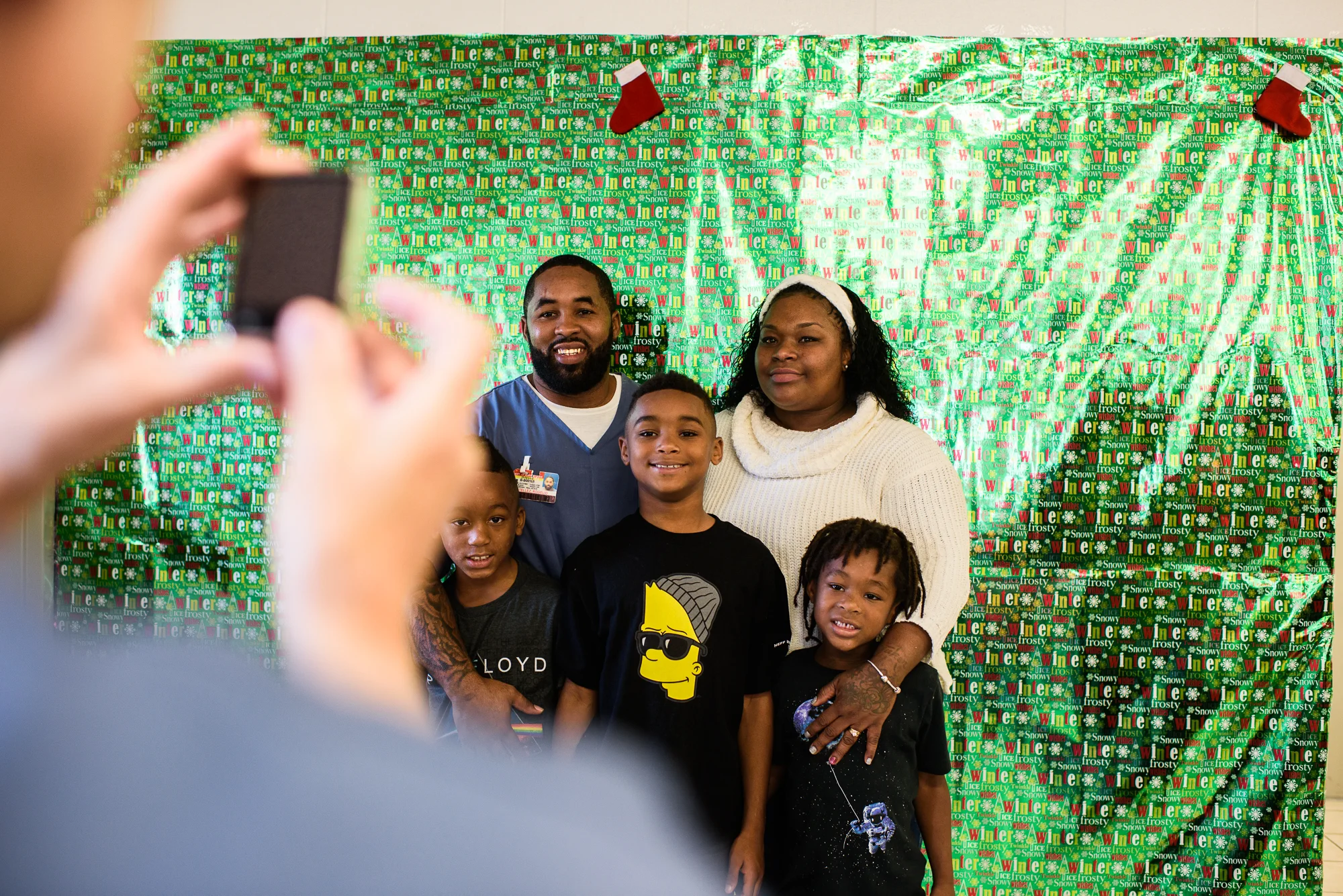 Rogelio and Sandrika stand with their sons, Rodarion, age 9, Rohandrick, age 6, and Romarion, age 4, for a Christmas picture at the Everglades Reentry Center in Miami, Florida.