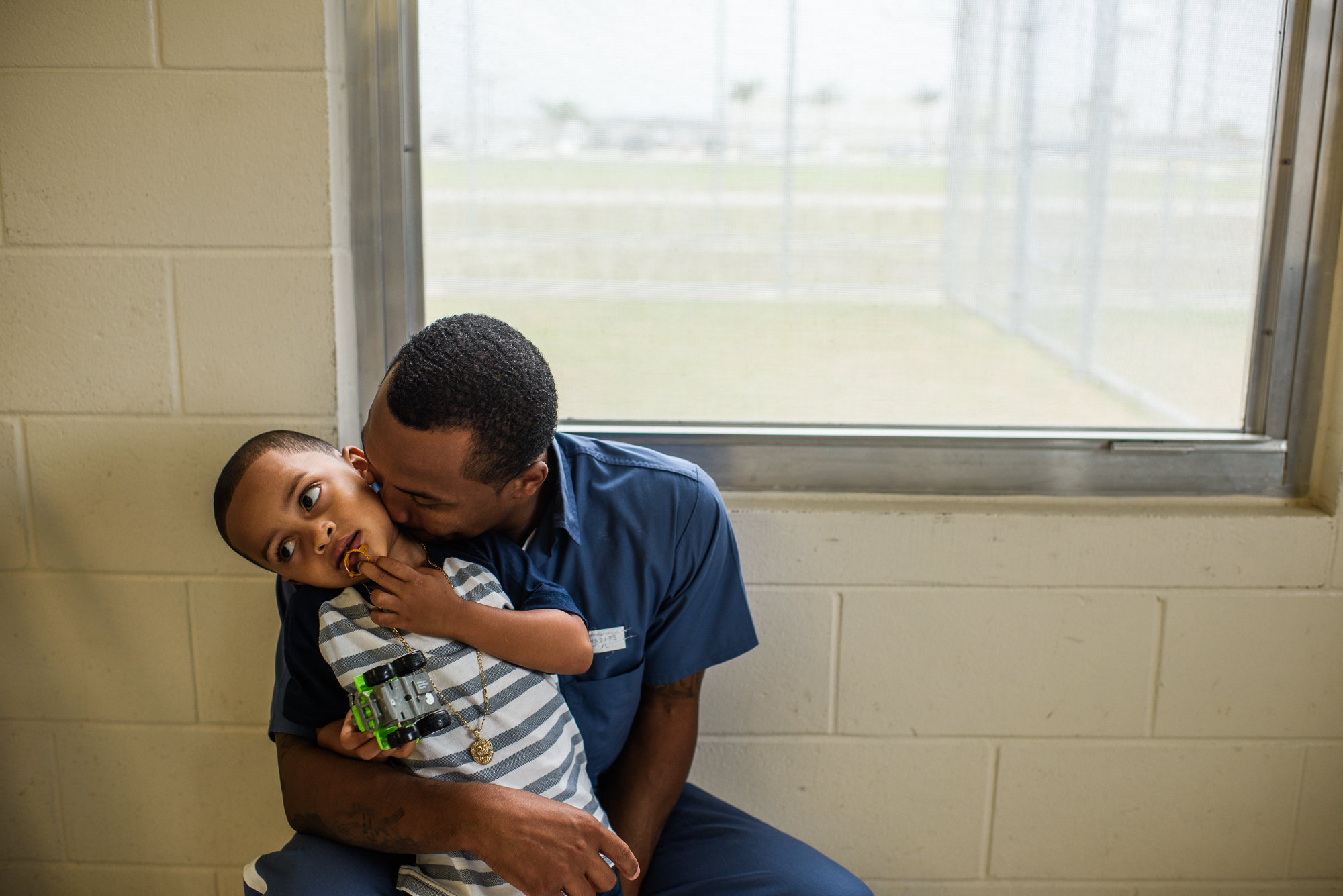  Arnaldo, age 28, kisses his son Joseph, age 4, during a visit at the Okeechobee Correctional Institution in Okeechobee, Florida, where Arnaldo is incarcerated. “My son asks me, ‘When are you getting out of time-out?’ I tell him the reality of where 