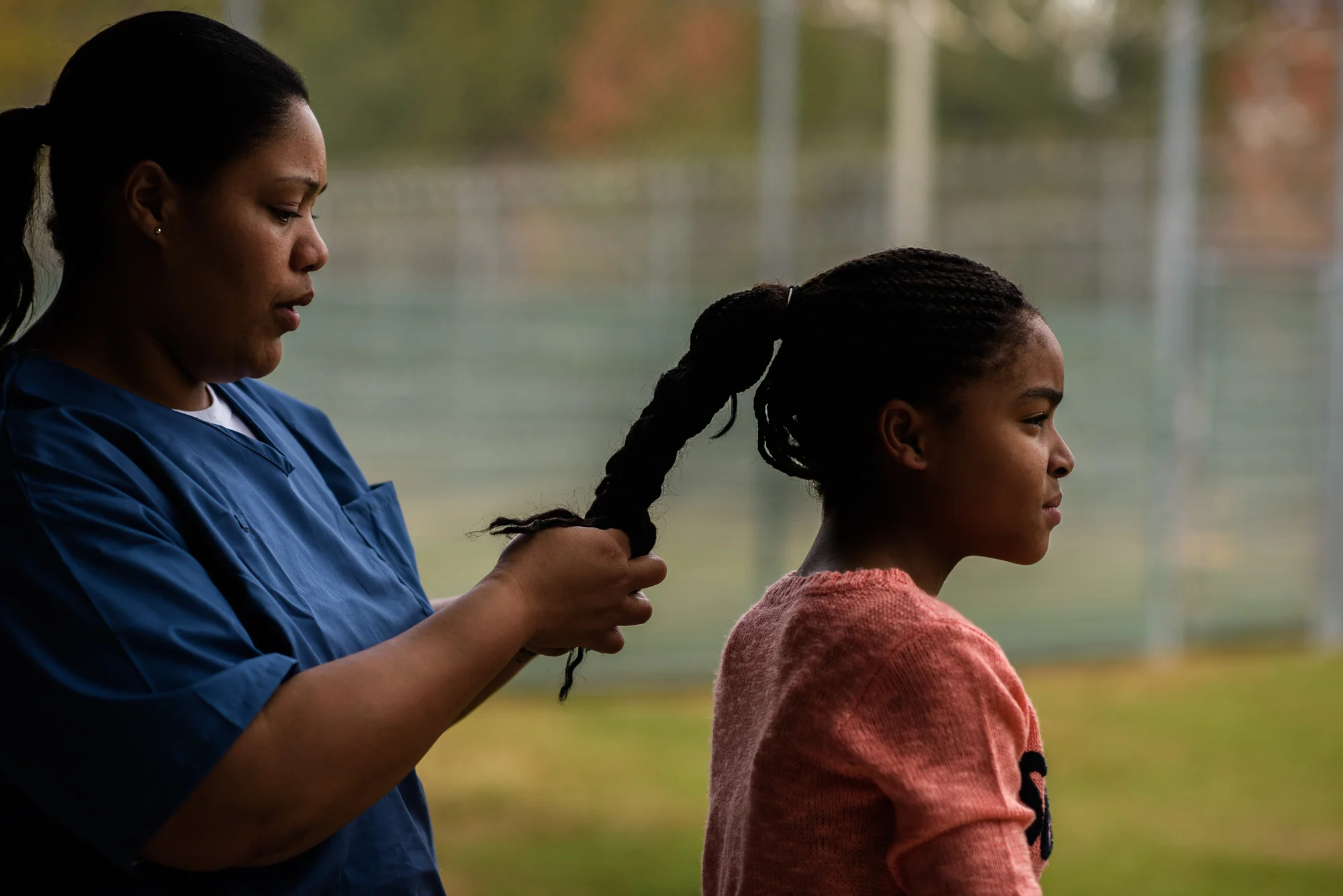 A mother braids her daughter’s hair in the recreation yard at the Lowell Correctional Institution in Ocala, Florida.