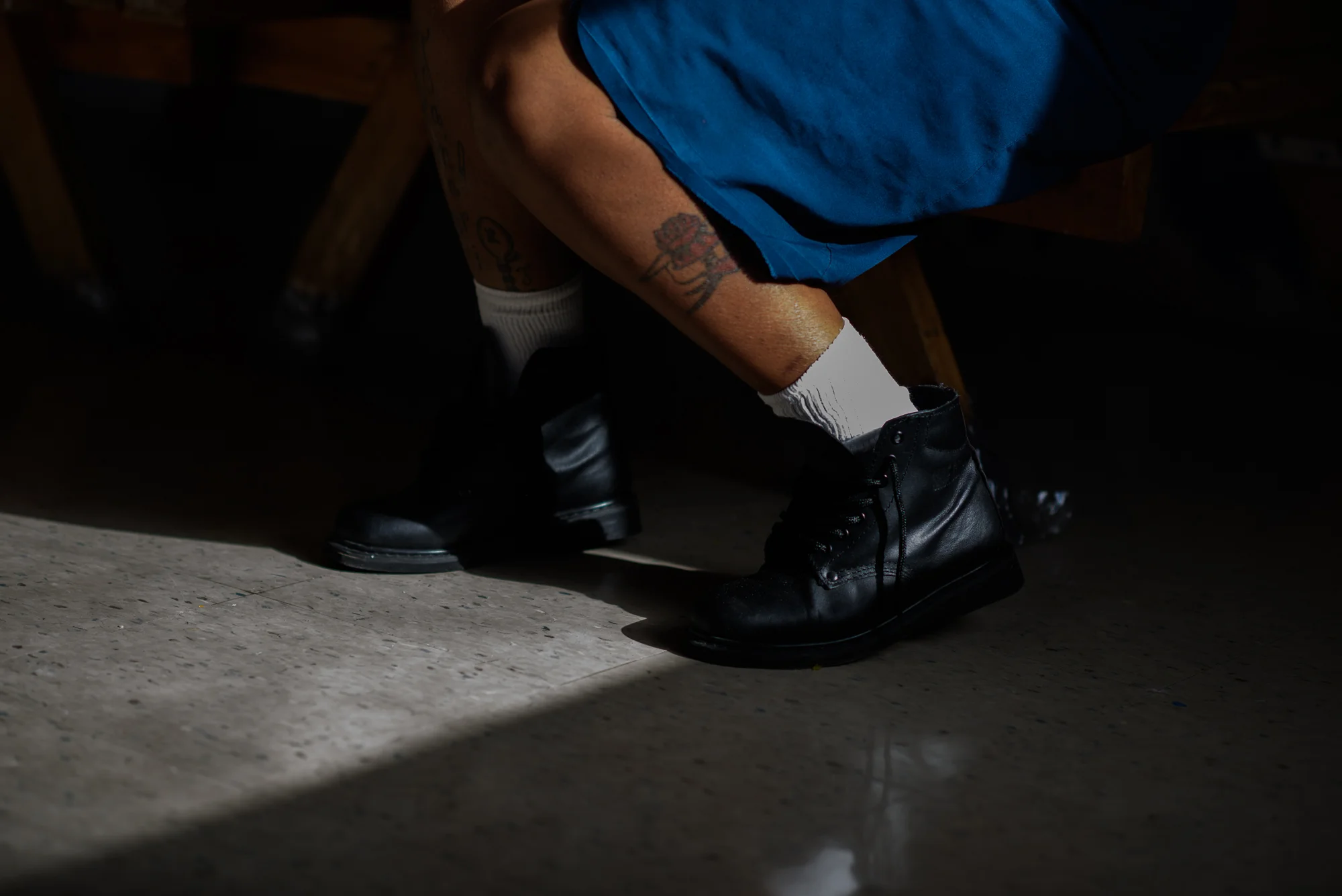 A woman’s leg as she sits during a mother-child visit at Homestead Correctional Institution in Florida City, Florida.