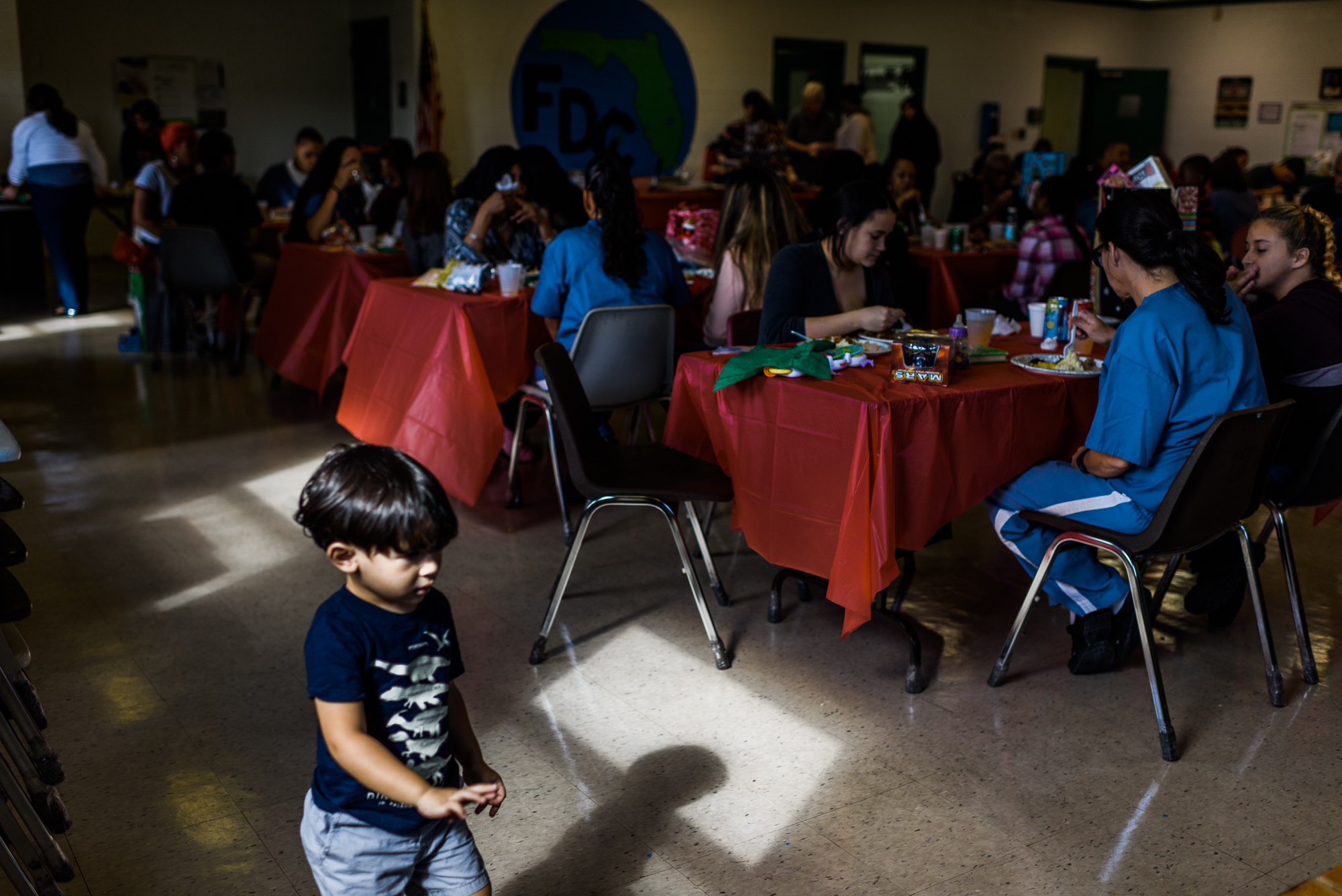  Jakey, age 2, paces beside tables of mothers and children at the Homestead Correctional Institution in Florida City, Florida. 