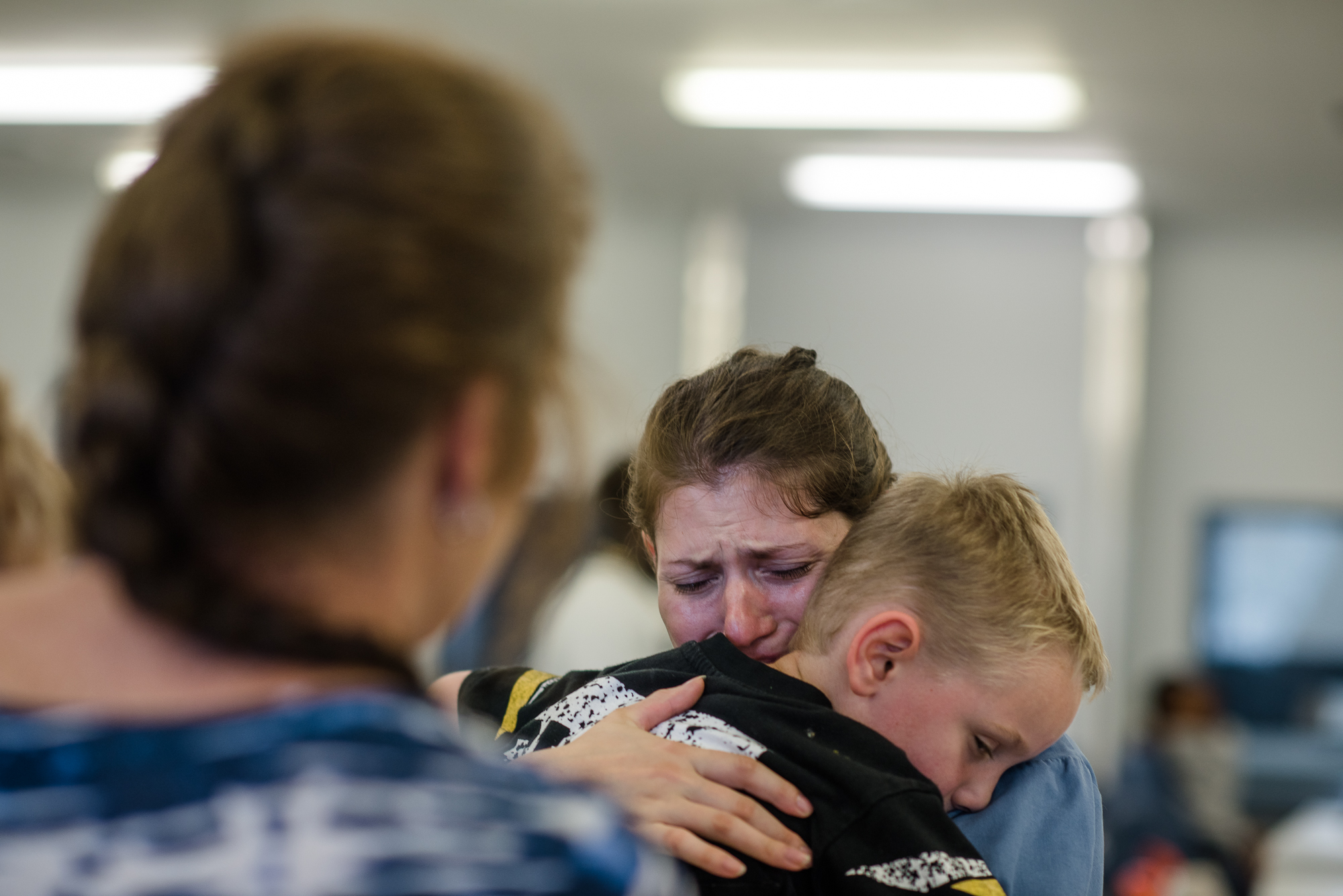  Jessie hugs her son goodbye as her mother stands with her during the end of a visit at the Lowell Correctional Institution in Ocala, Florida. 