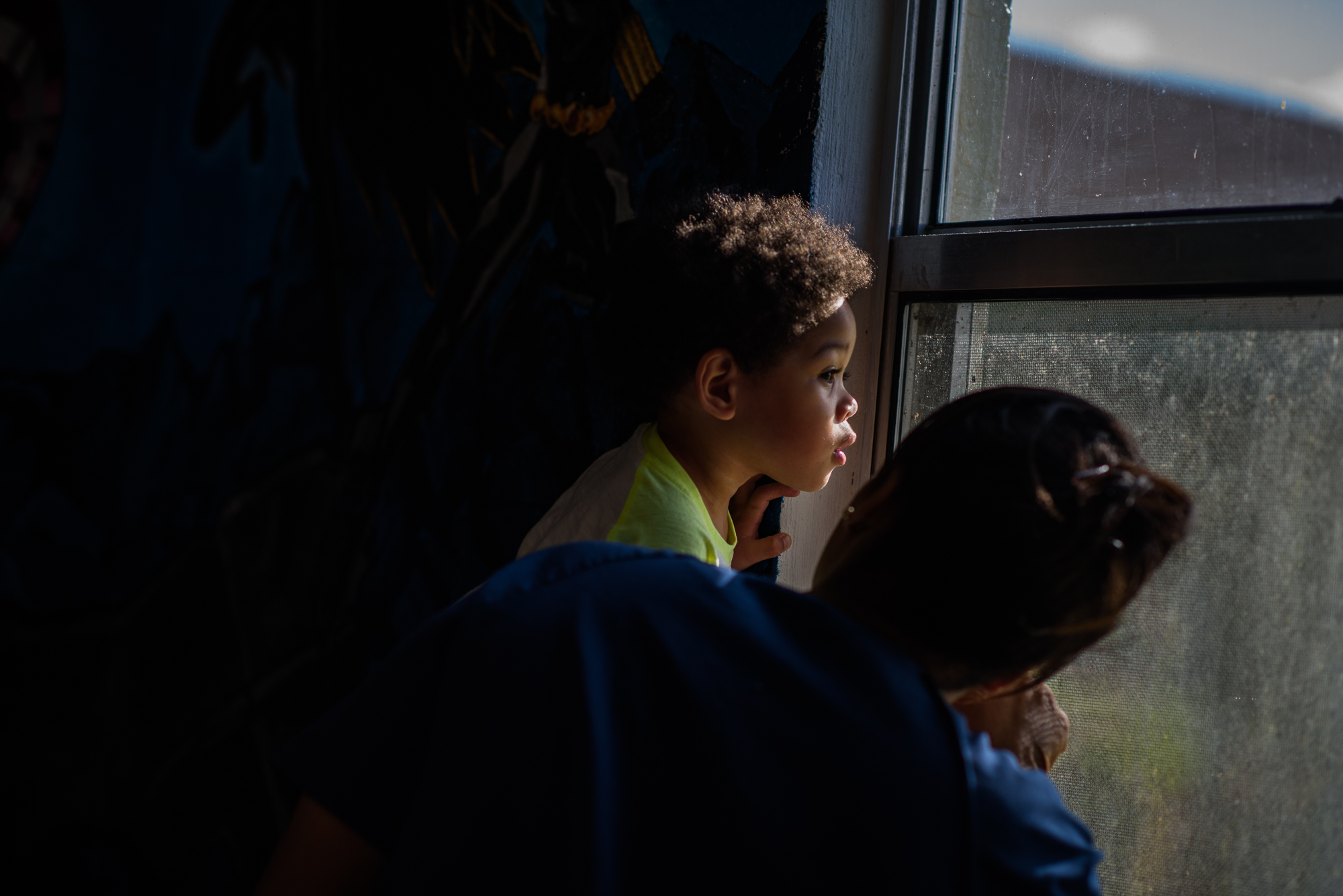  A boy looks out the window with his grandmother at the Homestead Correctional Institution. 
