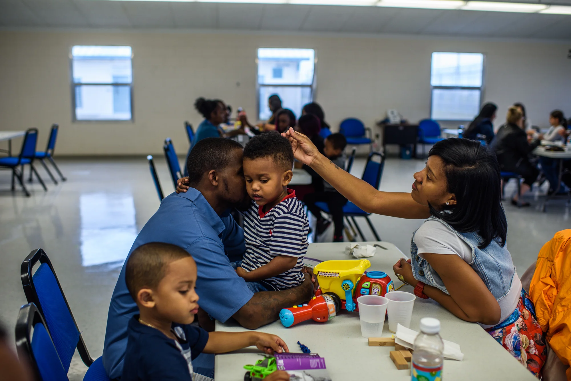A family interacts during a visit at the Okeechobee Work Camp in Okeechobee, Florida.