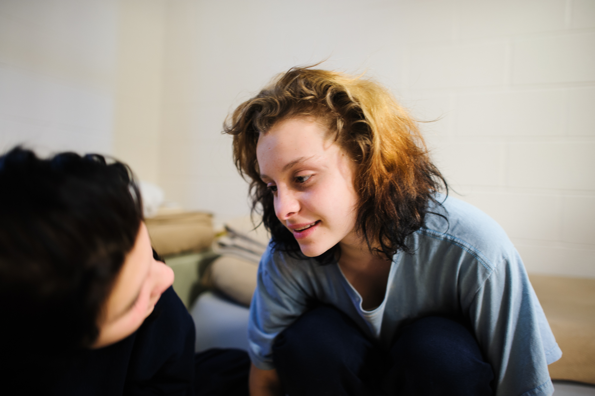  Alysia, age 16, and Jasmine, age 15, look into each other’s eyes, as they sit in their shared cell at the juvenile detention center.  