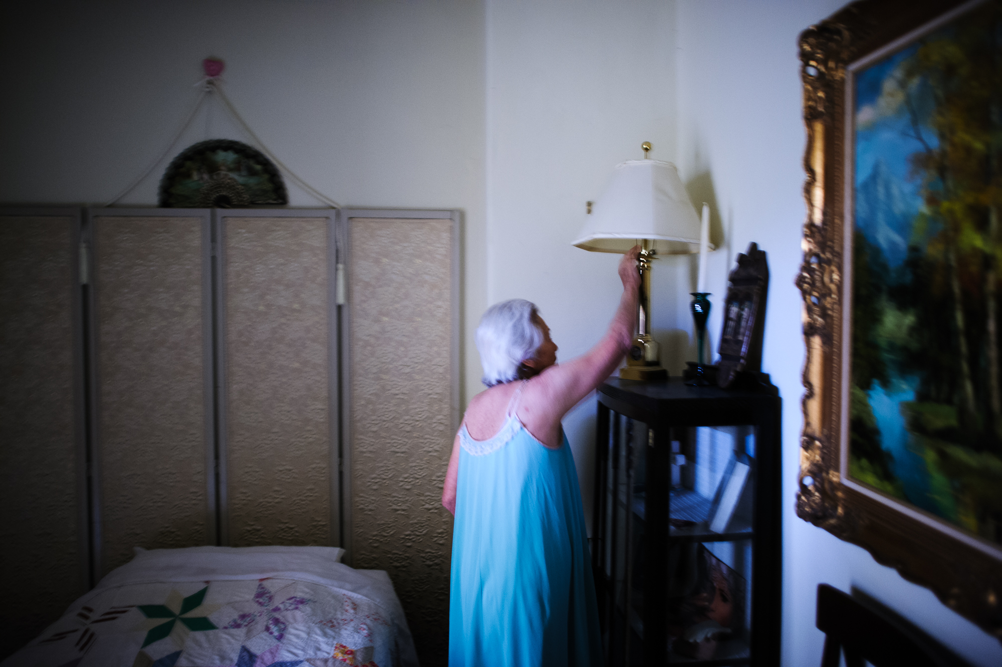  Bianca, age 84, turns on the light in her apartment at the retirement home at night, 2009.  