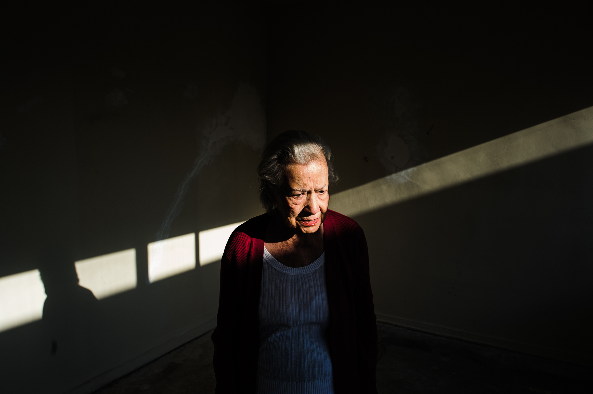  Bianca, age 85, stands in an empty apartment after deciding to switch apartments due to vertigo, 2010.  