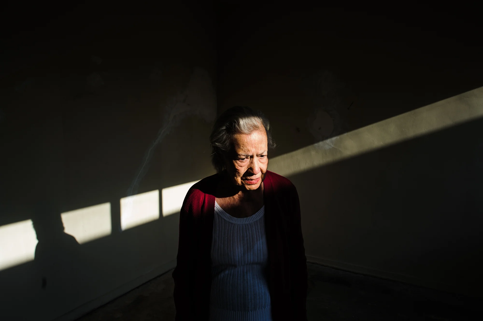 Bianca, age 85, stands in an empty apartment after deciding to switch apartments due to vertigo, 2010.
