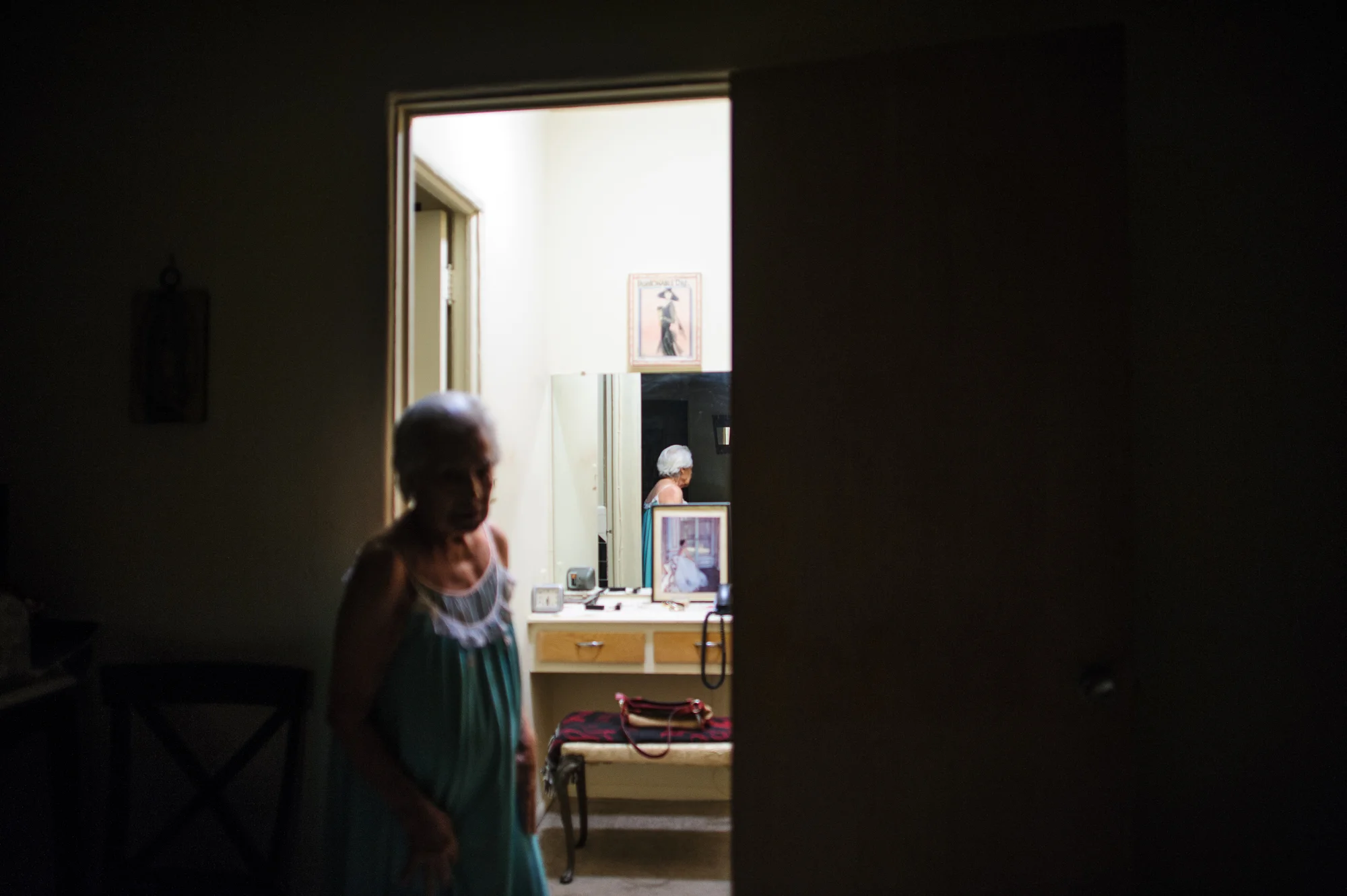 Bianca, age 86, stands in her apartment at night, 2011.