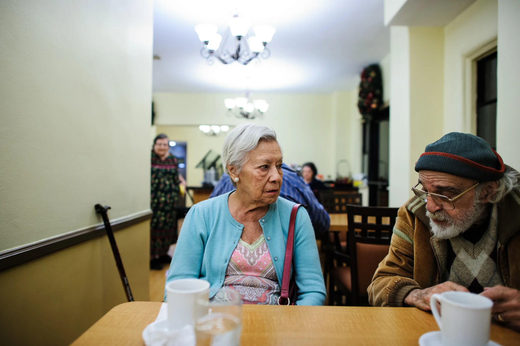 Bianca, age 86, sits with Bill during dinner hour at the retirement home, 2011.