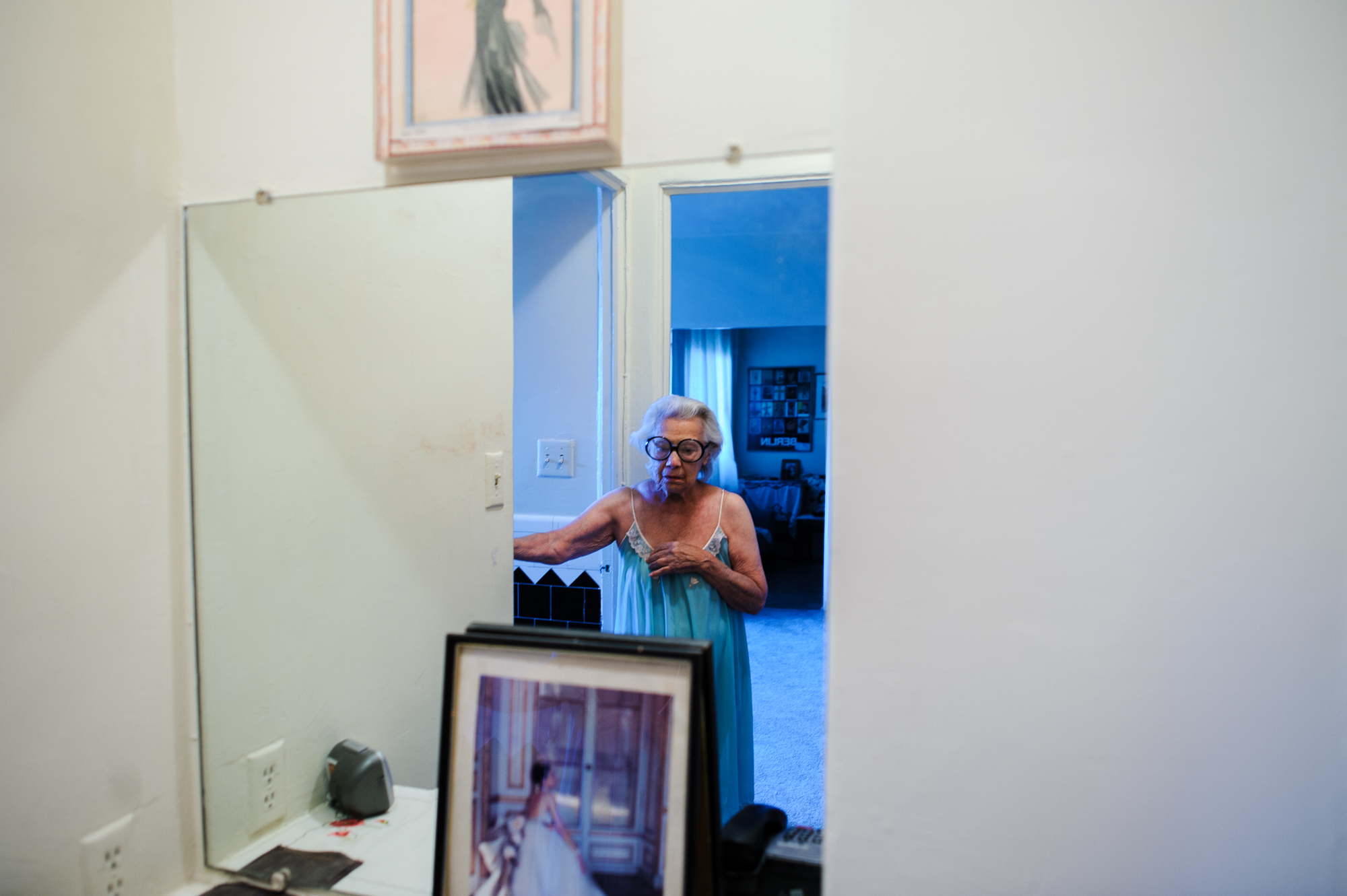  Bianca, age 85, wears her signature glasses and nightgown in front of her mirror, 2010.  