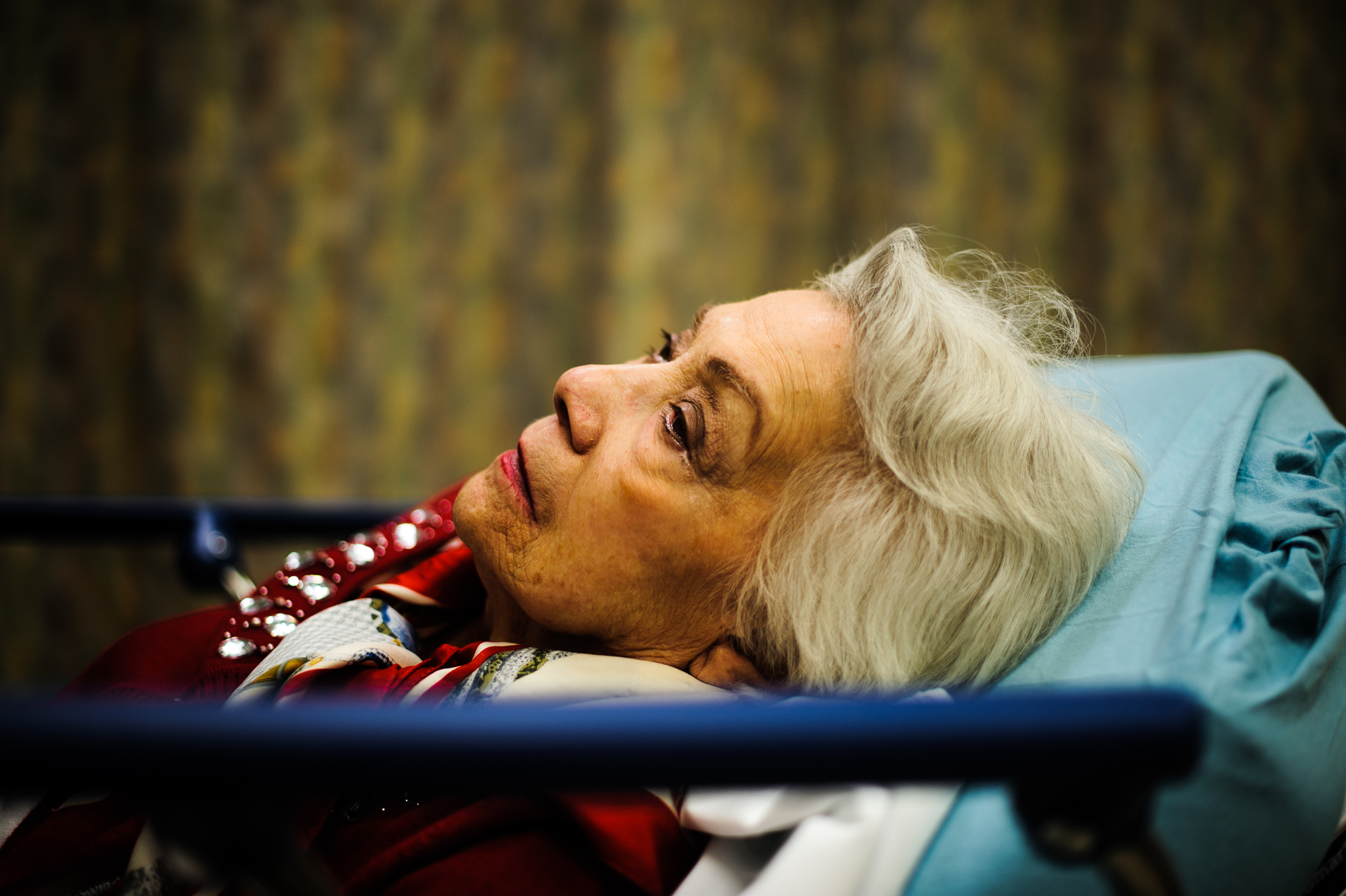  Bianca, age 88, lies on a bed in the emergency room after a fall, 2013.  