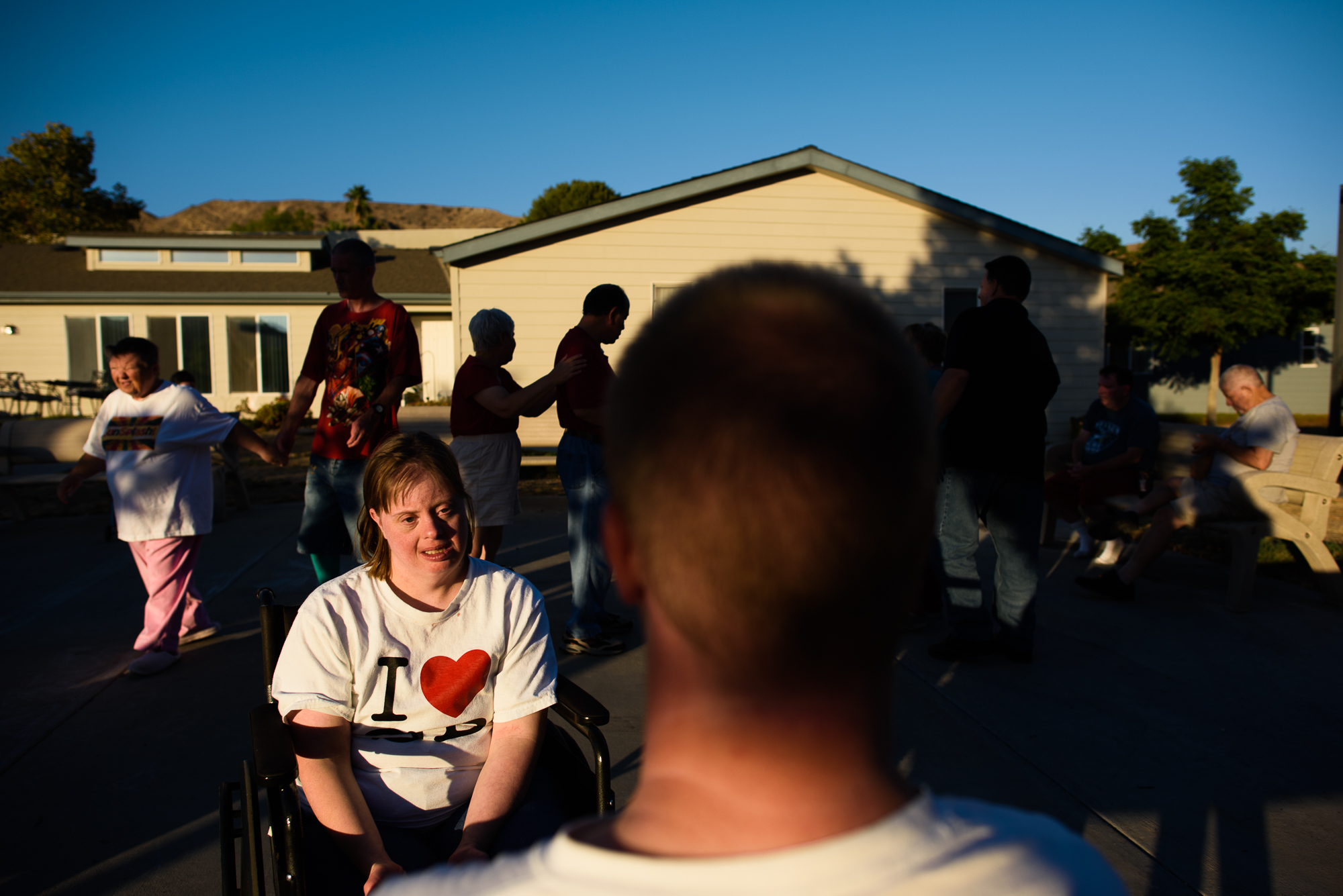 Krysta sits with Nathaniel during a dance party outside the homes at the ranch.