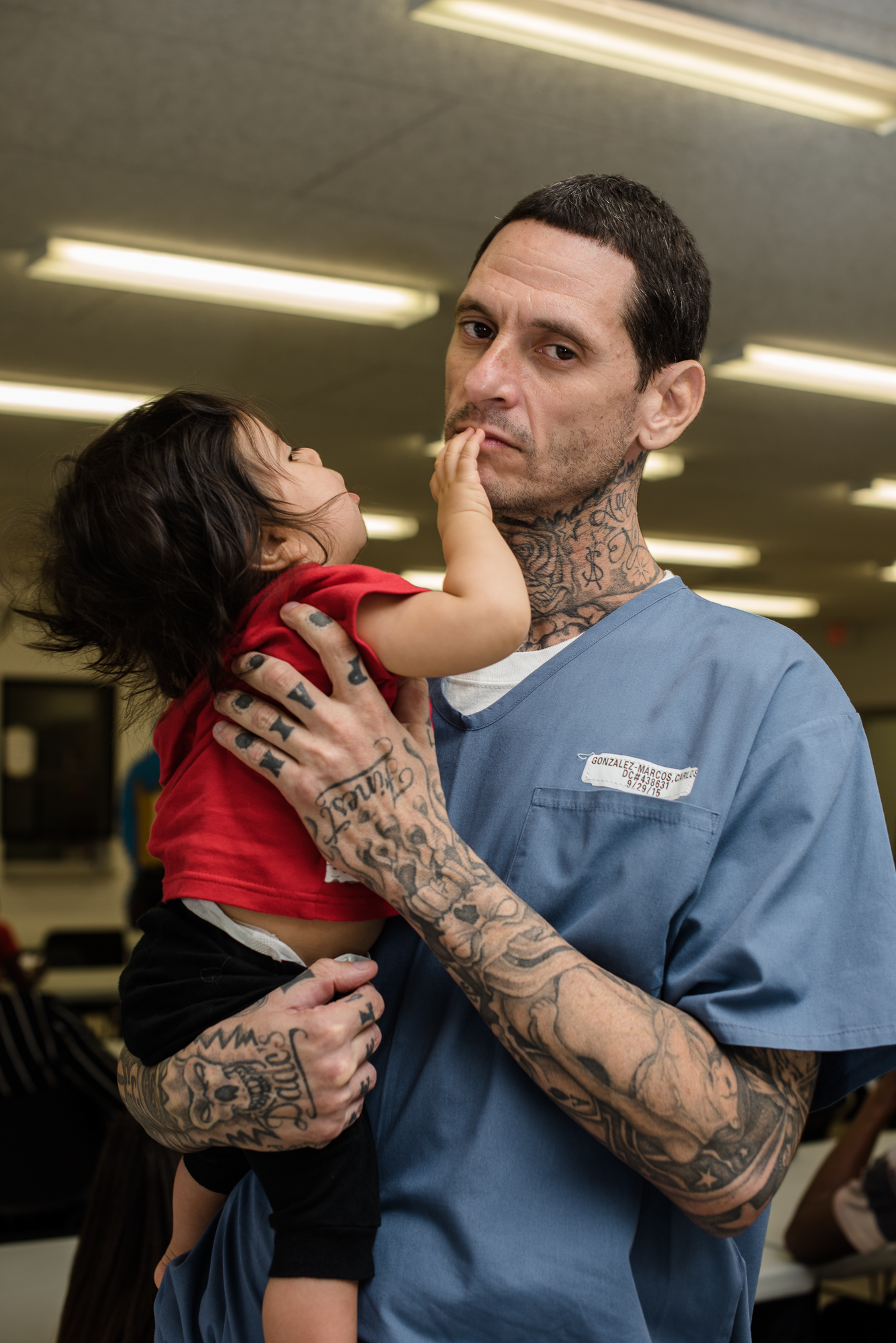  Carlos holds his son, Damian, during a visit at the Everglades Reentry Center; Carlos hopes to become a counselor upon release and work beside his wife who is a drug detox clinician.  