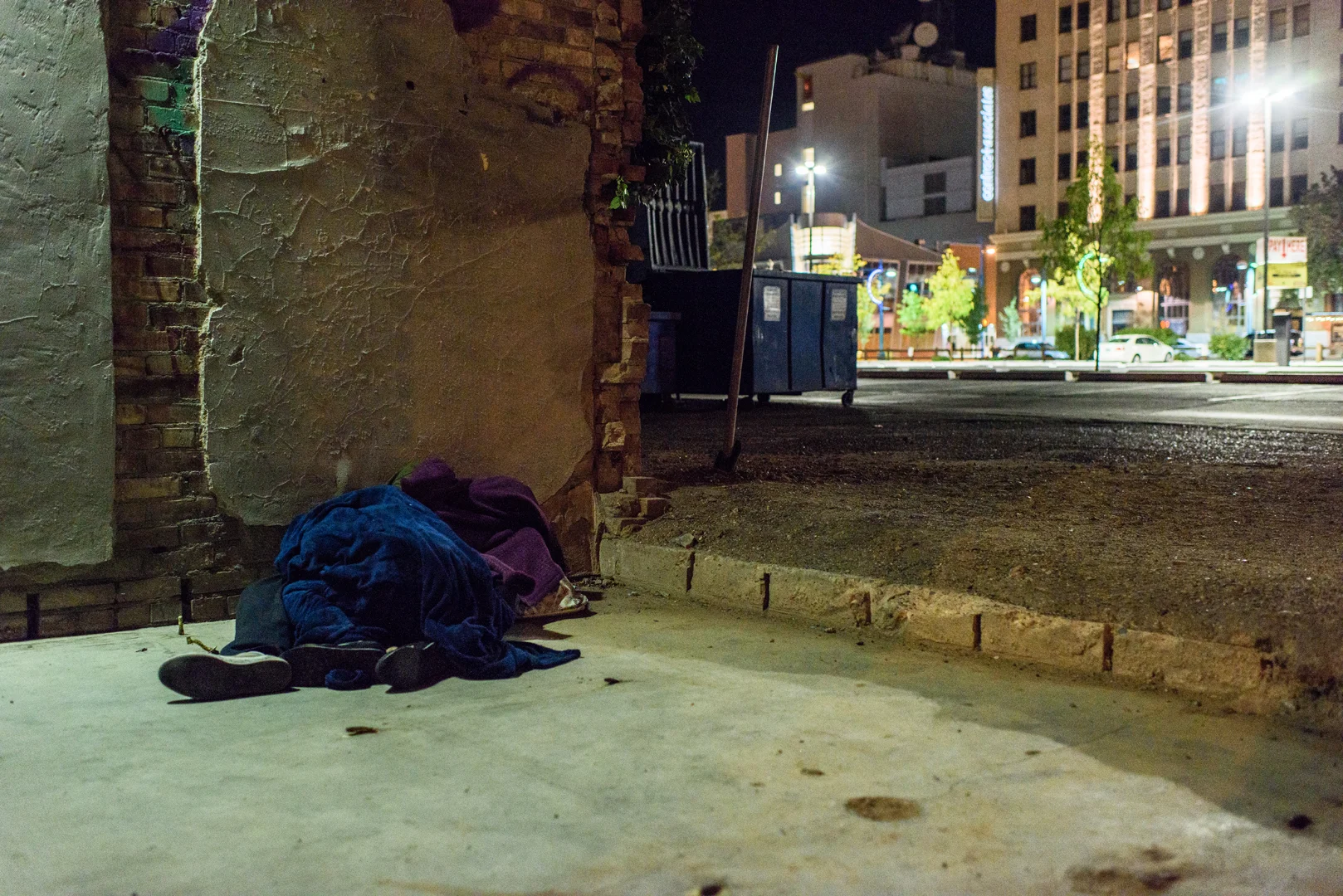 Delilah sleeps on the street next to Joseph, a man she met, after CJ is arrested and sent to prison.