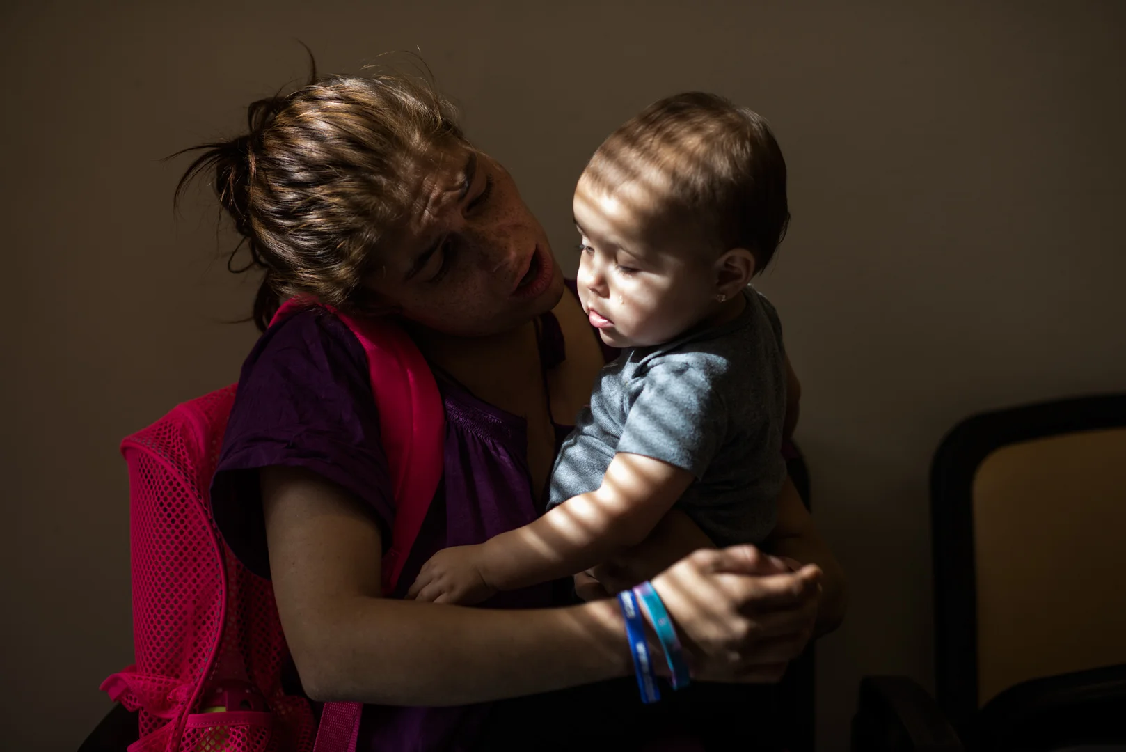 Delilah holds her daughter, Espy, on her lap during a visit at child protective services; her daughter currently lives with her aunt.