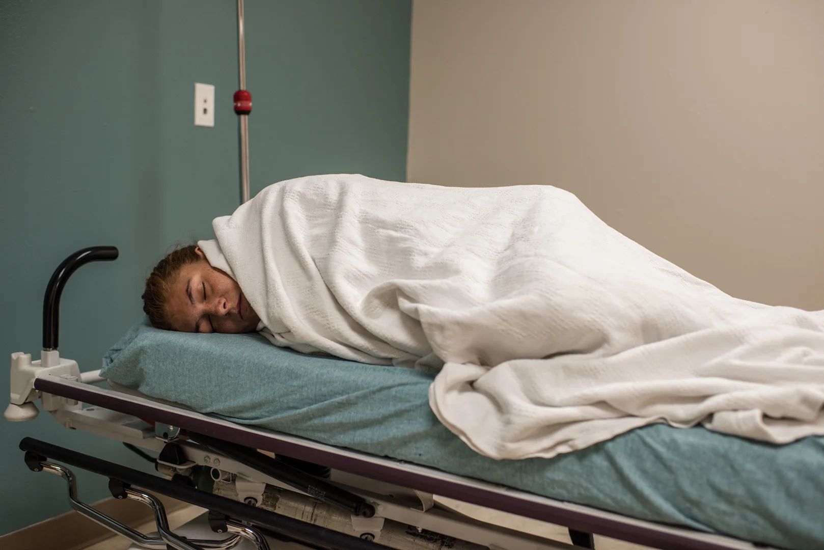 Delilah lies on a bed in the hospital.