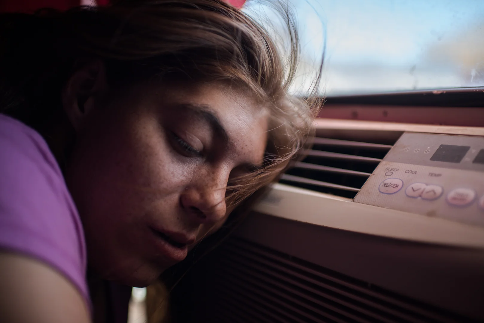 Delilah rests her head on an air conditioner in Crystal, Alex’s mom’s, apartment, after her release from the hospital.