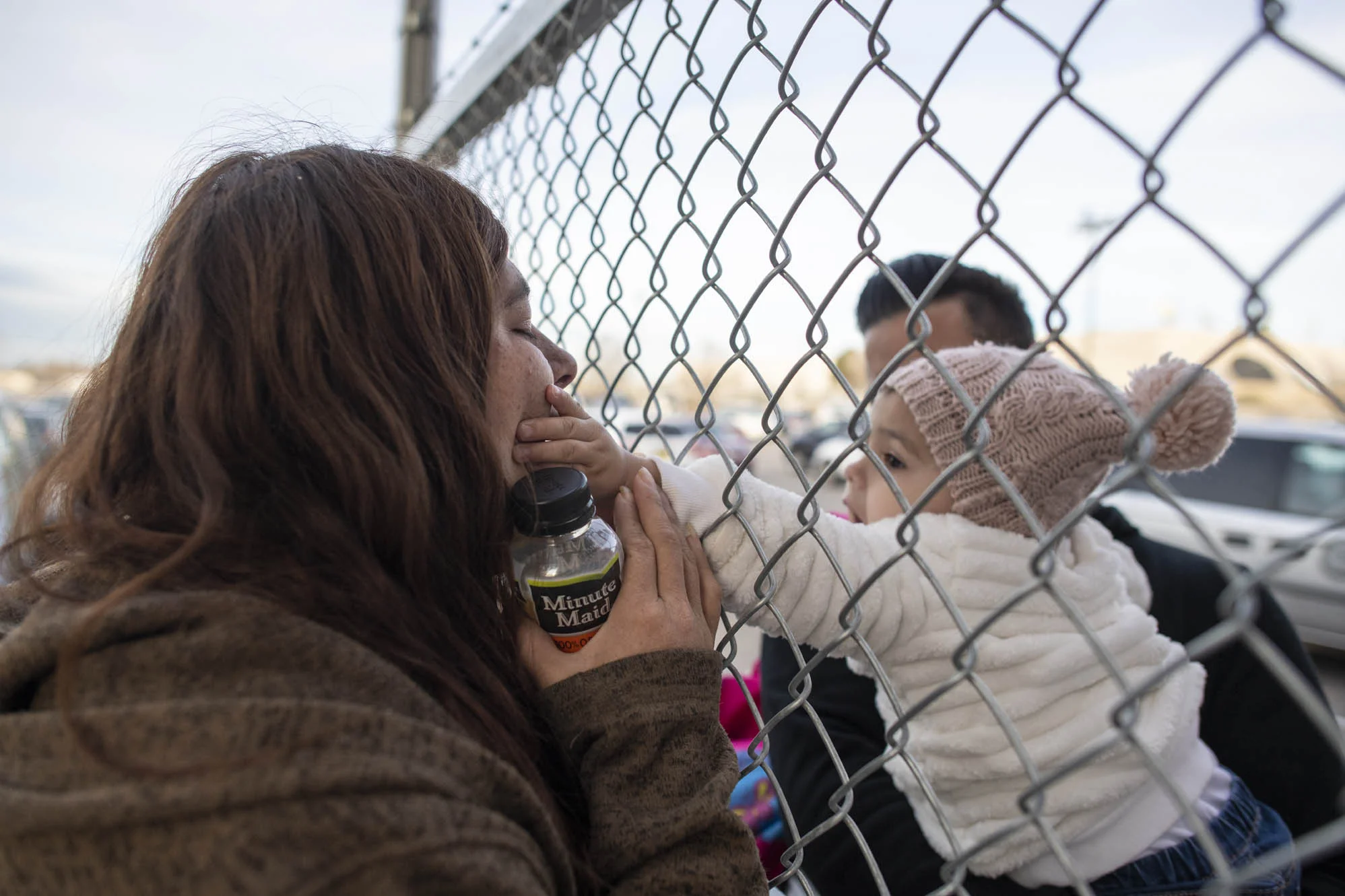 Esperanza grabs Delilah’s face through a fence at the end of the visit.