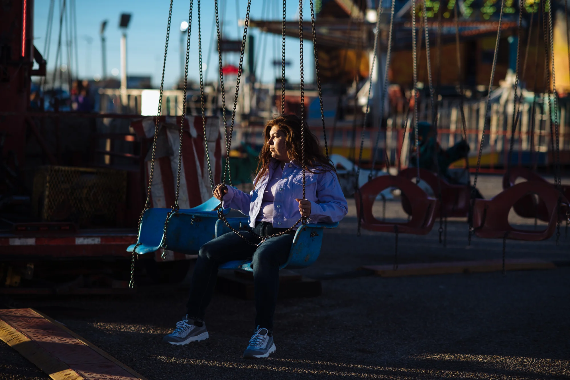 Delilah sits on a ride at an annual carnival.