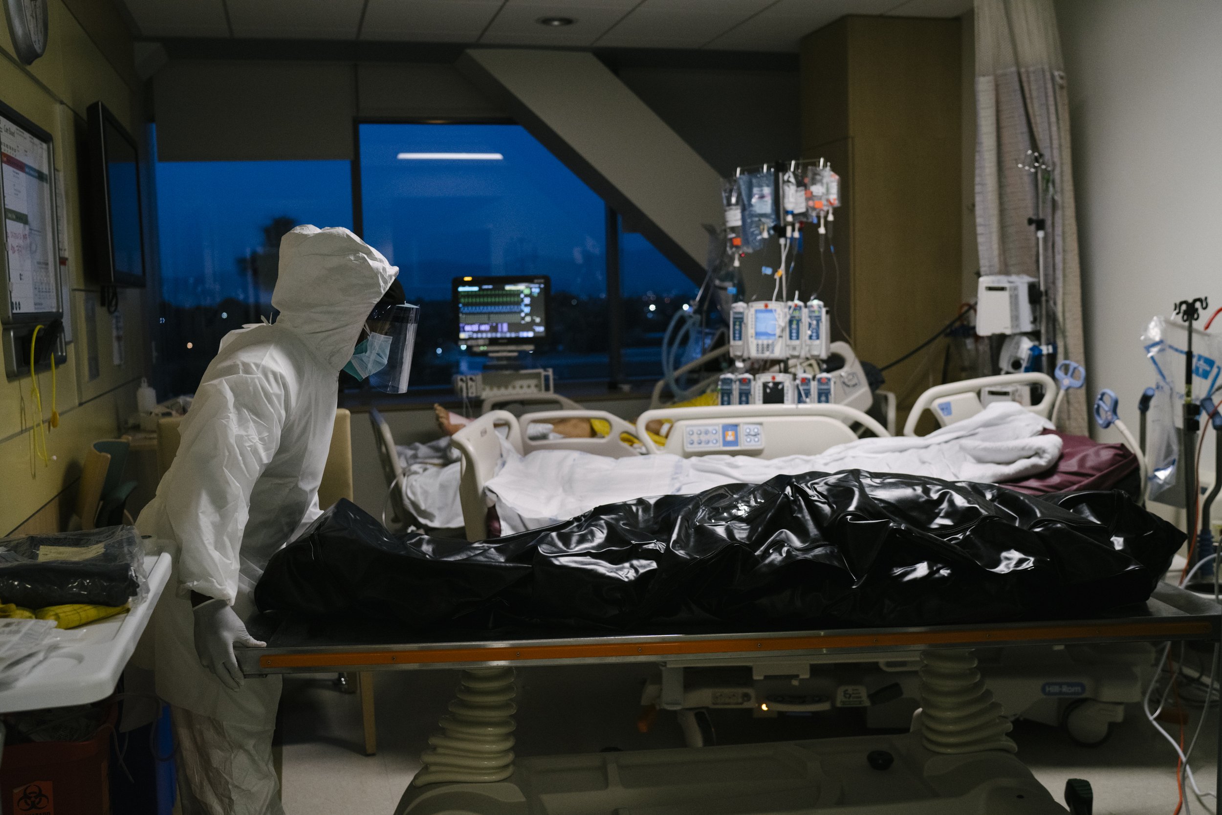  B.J. Brown Jr, a member of the transport team, prepares to take a body of a patient with Covid-19 from the ICU to the hospital morgue at M.L.K Jr. Community Hospital in South Los Angeles, California.. Mr. Brown has worked at the hospital since it op