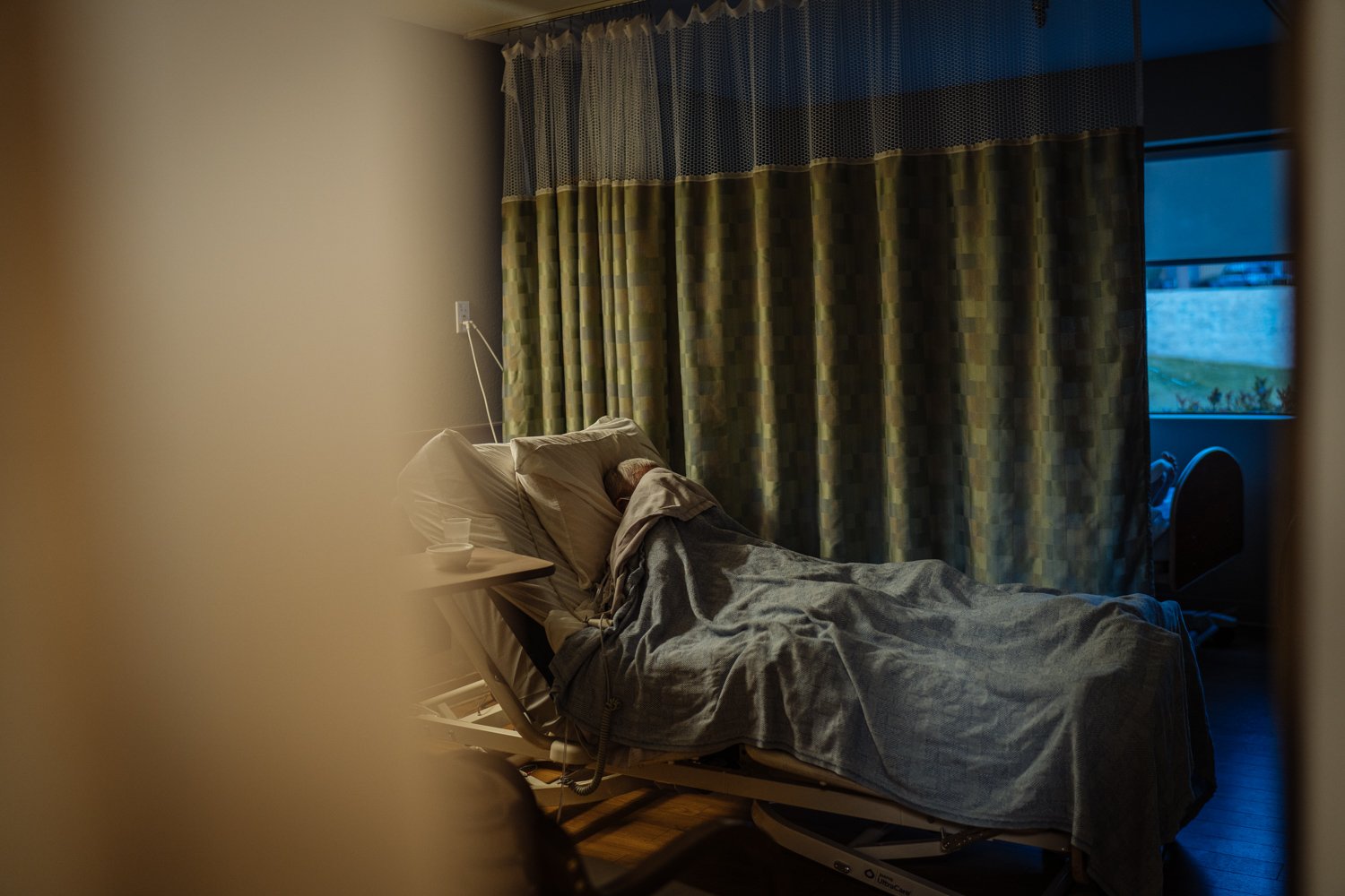  Mr. Montoya, 94, in his room with his face covered.  