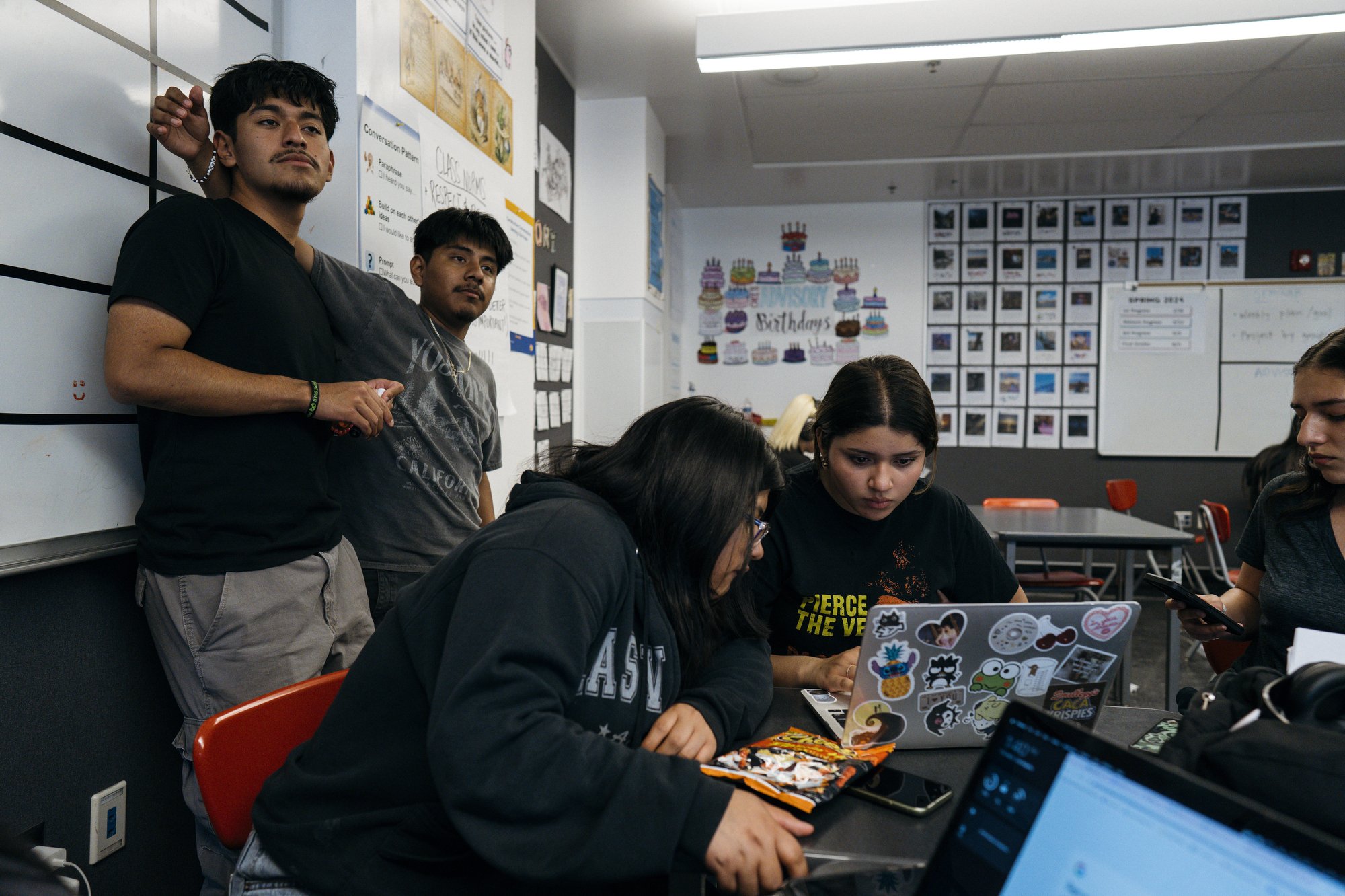  Javir and Joshua, who is also in the 12th grade and has attended the school since kindergarten, stand together, as other students study nearby, during homeroom.  “I have more connection to my classmates, so I was able to look for systems of support 