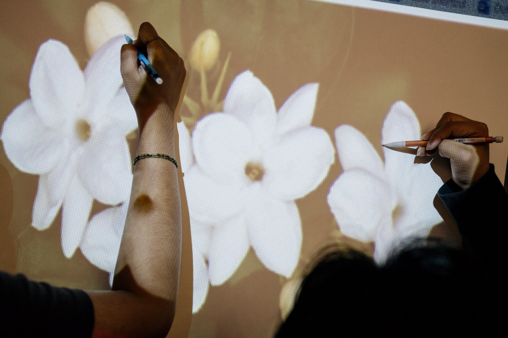 Sujana draws with a fellow member of the Student Advisory Council; here, they are making posters about countries reflected in students’ backgrounds in honor of Asian American Pacific Islander Month.&nbsp; Speaking about the school being located in K