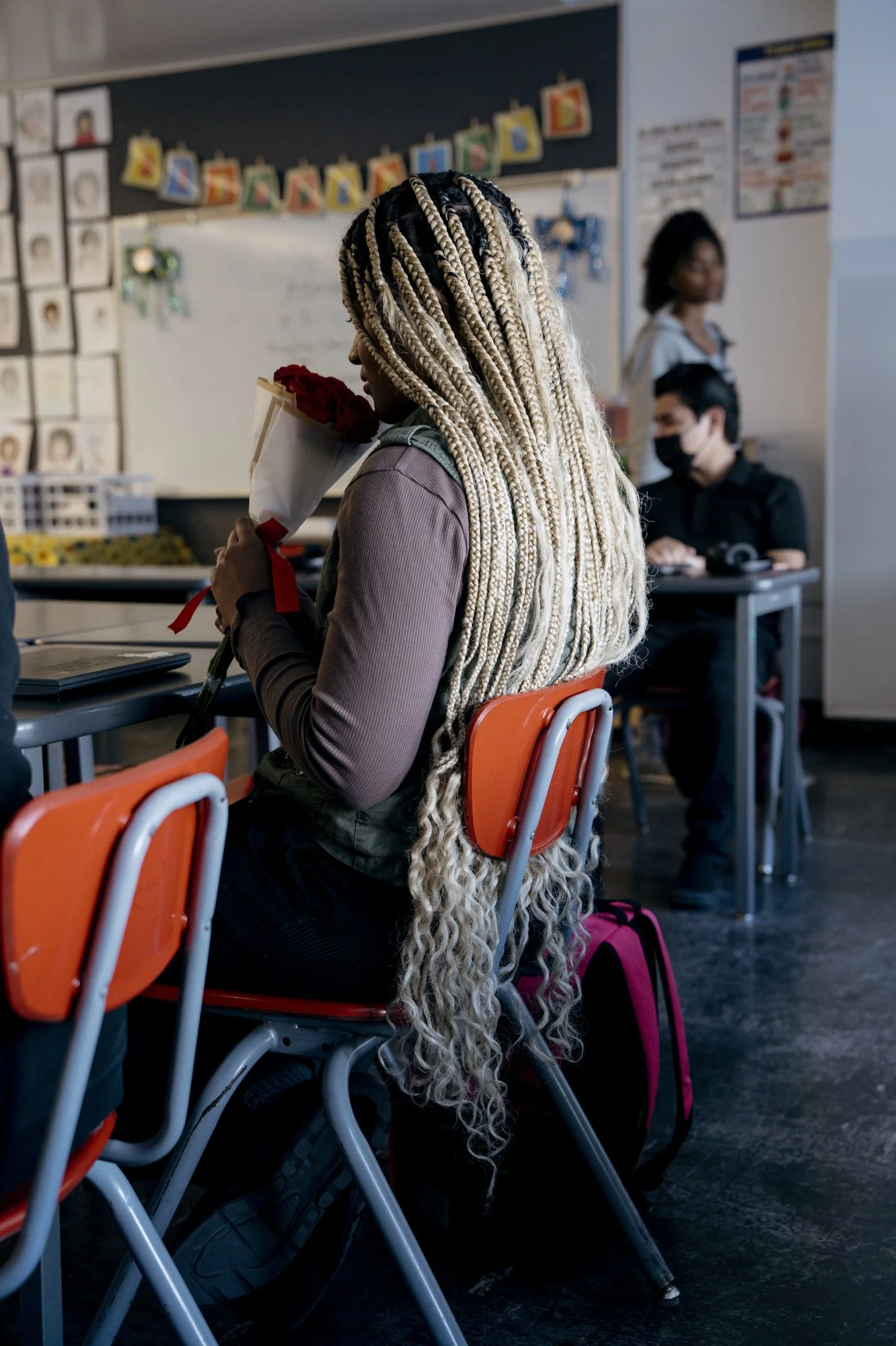  Kaelin, a student in the 10th grade, sits in Spanish class; holds up a bouquet of roses that were delivered to students for their mothers on Mother’s Day. UCLA-CS is a dual language school. In Grades 9–12, both new and continuing students enroll in 