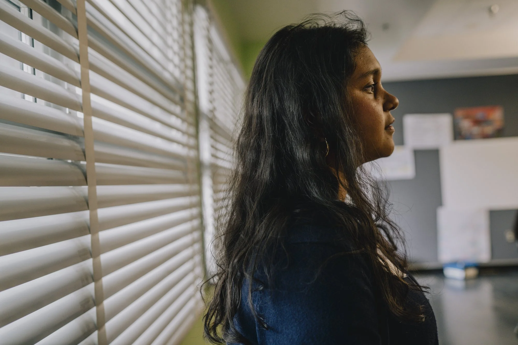  Sujana waits for parents and students to arrive in a classroom at Parent’s Night.  “Our school fosters or has this kind of college-going culture where they really encourage students to go to college,”  said Sujana.  “Whether that's like getting a tw