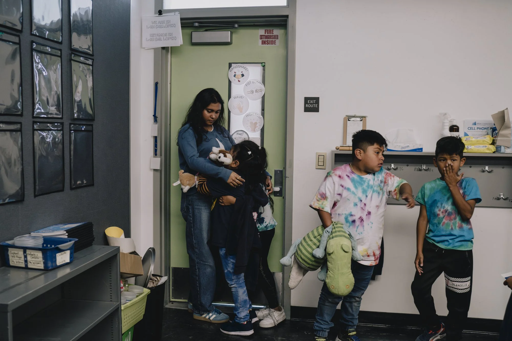  Sujana, a student in the 11th grade, who works as a teacher’s assistant in the afterschool program, embraces students at the UCLA Community School in Los Angeles, California. 