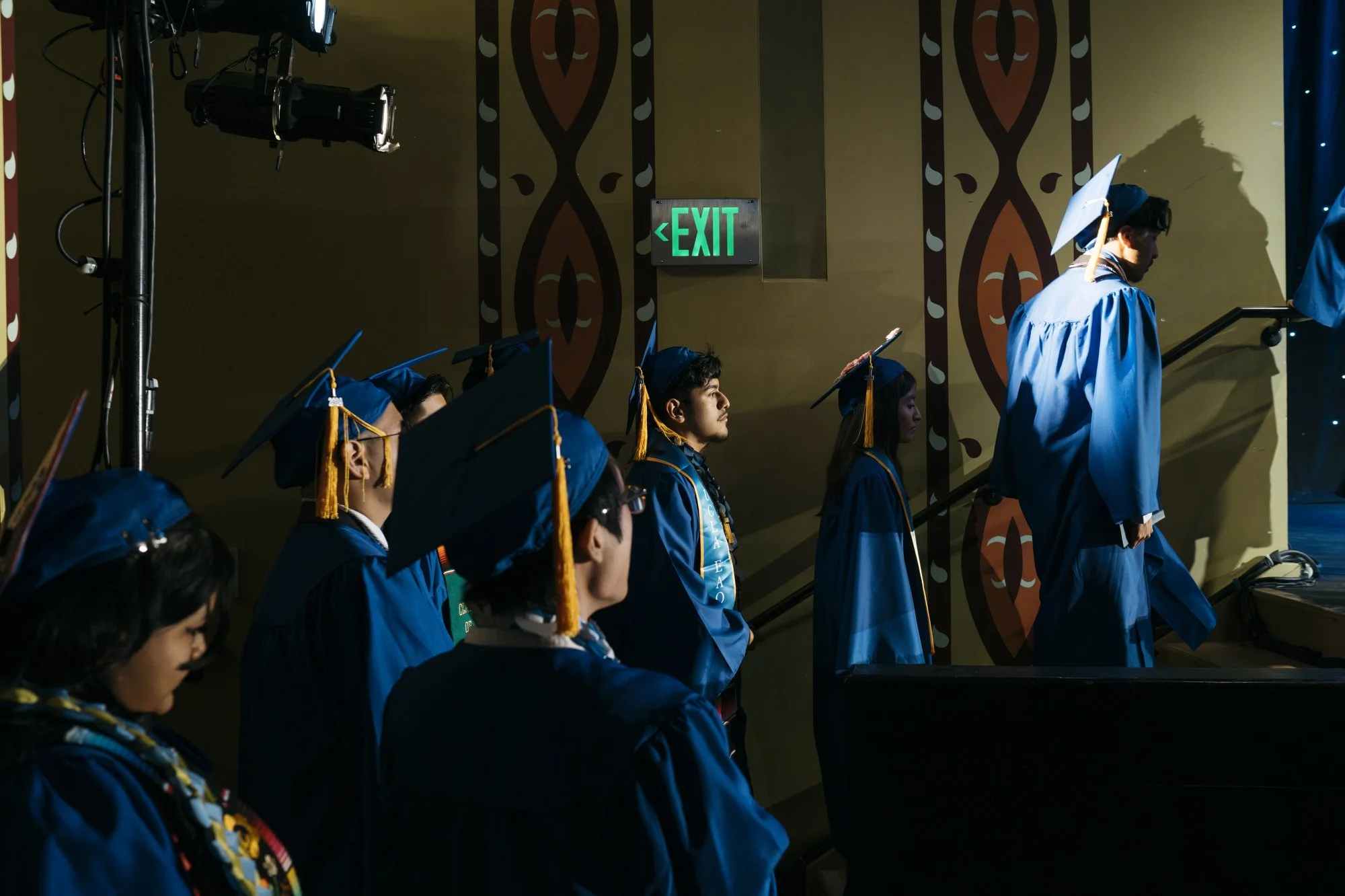  Javir lines up before walking the stage during graduation. Although almost all UCLA-CS graduates (97%) leave the school with a plan to enroll in a 4-year or community college, the immediate college enrollment is 82%, which is more than 20 percentage