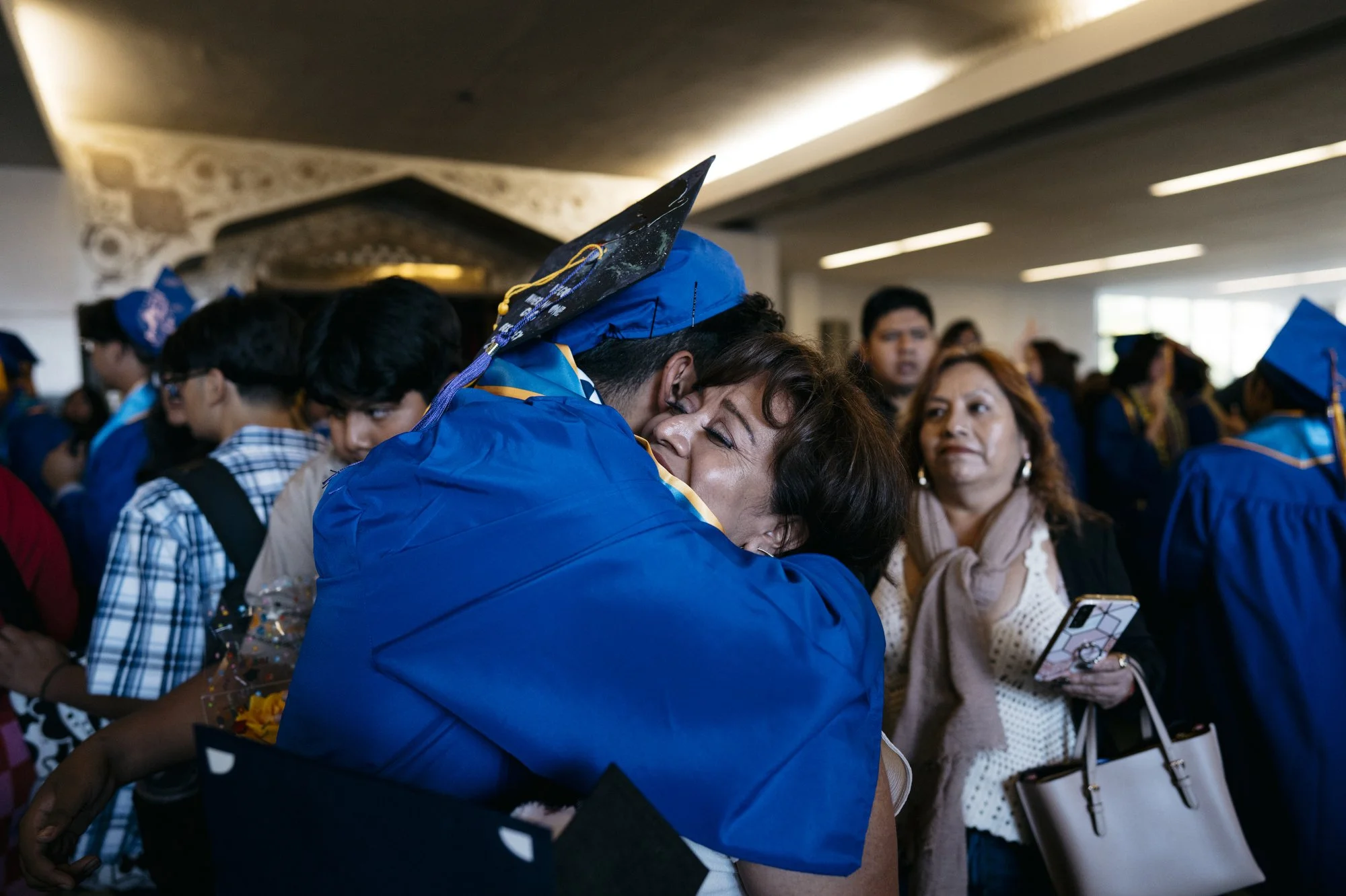  Javir embraces his mother, Janette, after graduation at the UCLA Community School in Los Angeles, California.  “We are looking forward to the next chapter of our lives,”  said Javir. 