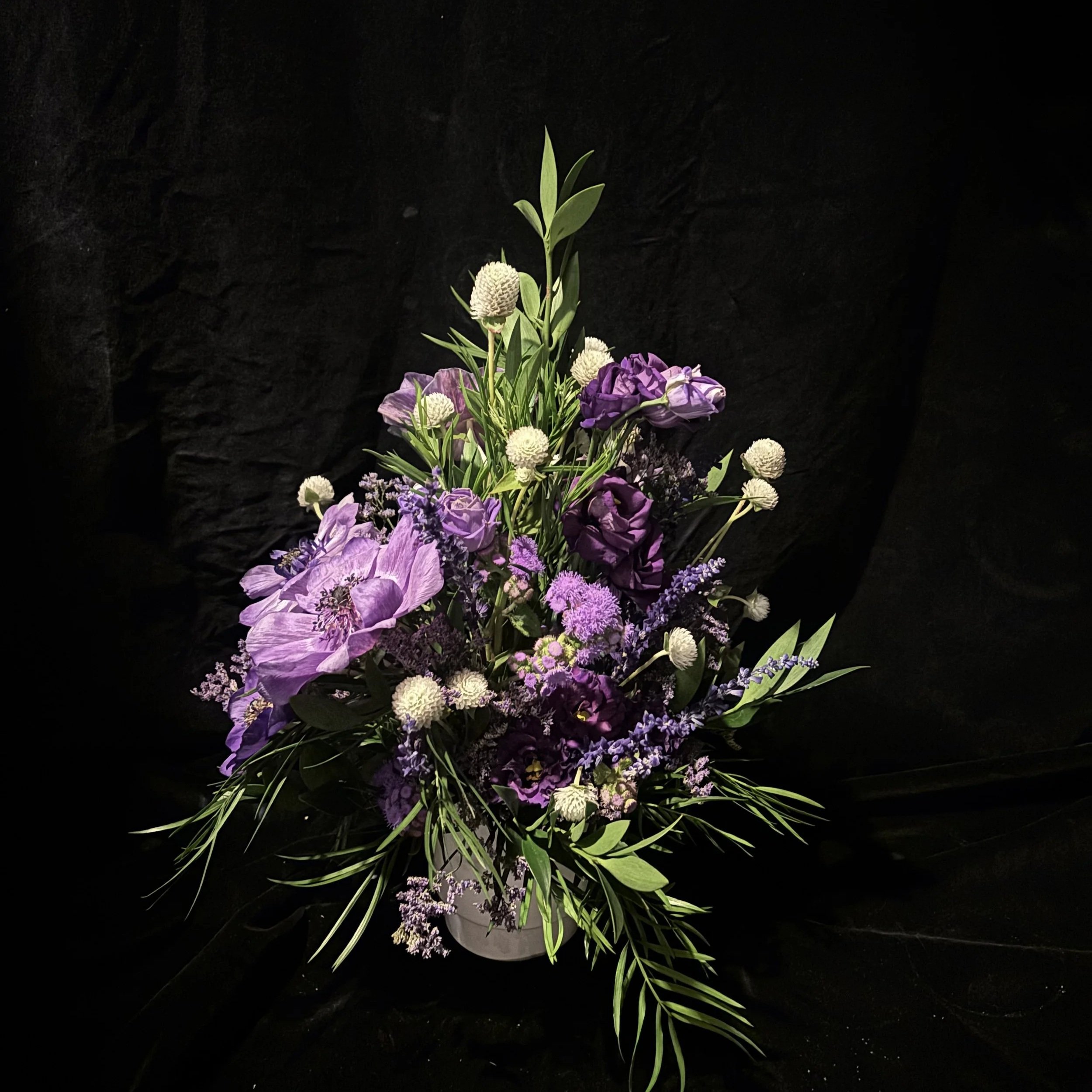 A medium Chanukah arrangement in purple and white by fleursBELLA featuring anemones