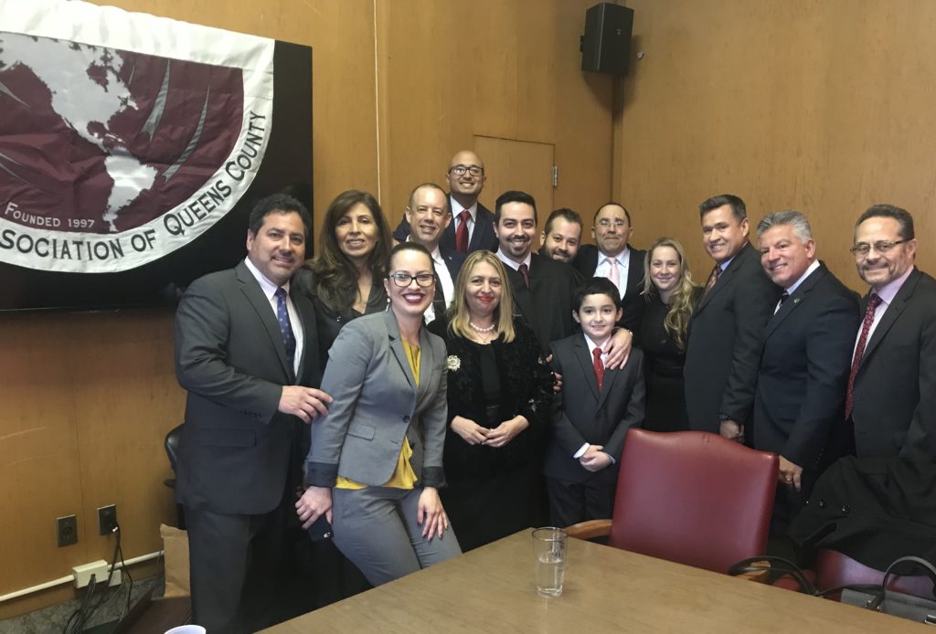 Cruz (front row, gray suit) and other members of the LLAQC // Photo courtesy of Catalina Cruz